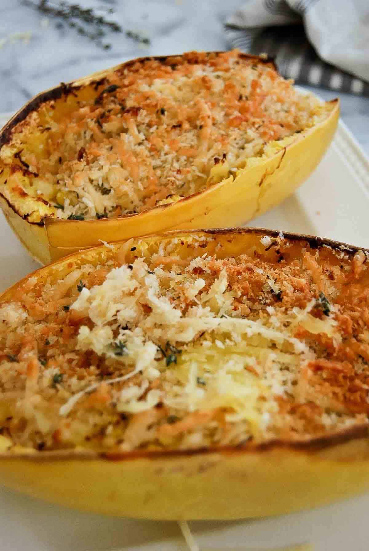 air fryer spaghetti squash with toasted cheese and breadcrumbs on top.