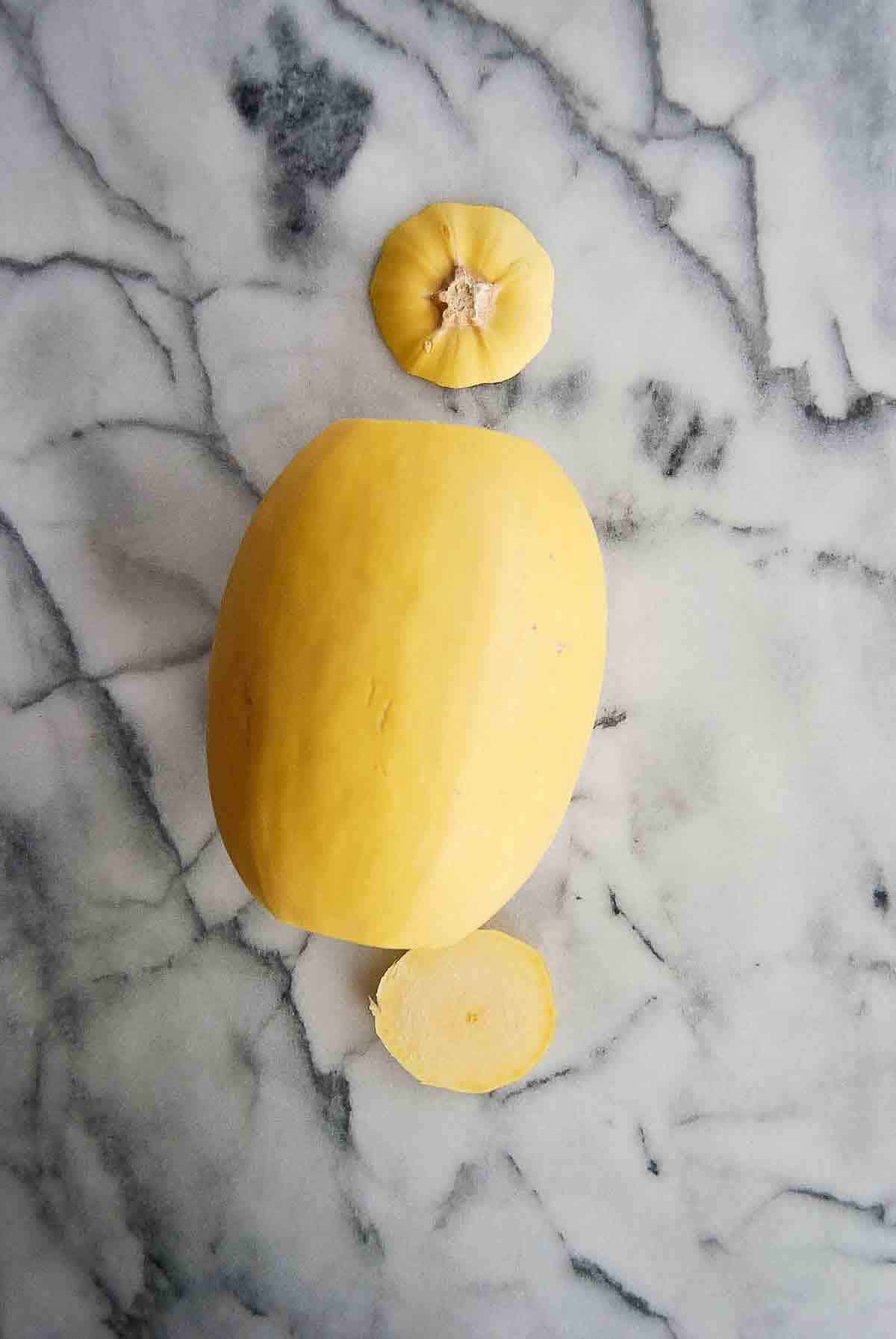 spaghetti squash on countertop with ends cut off.