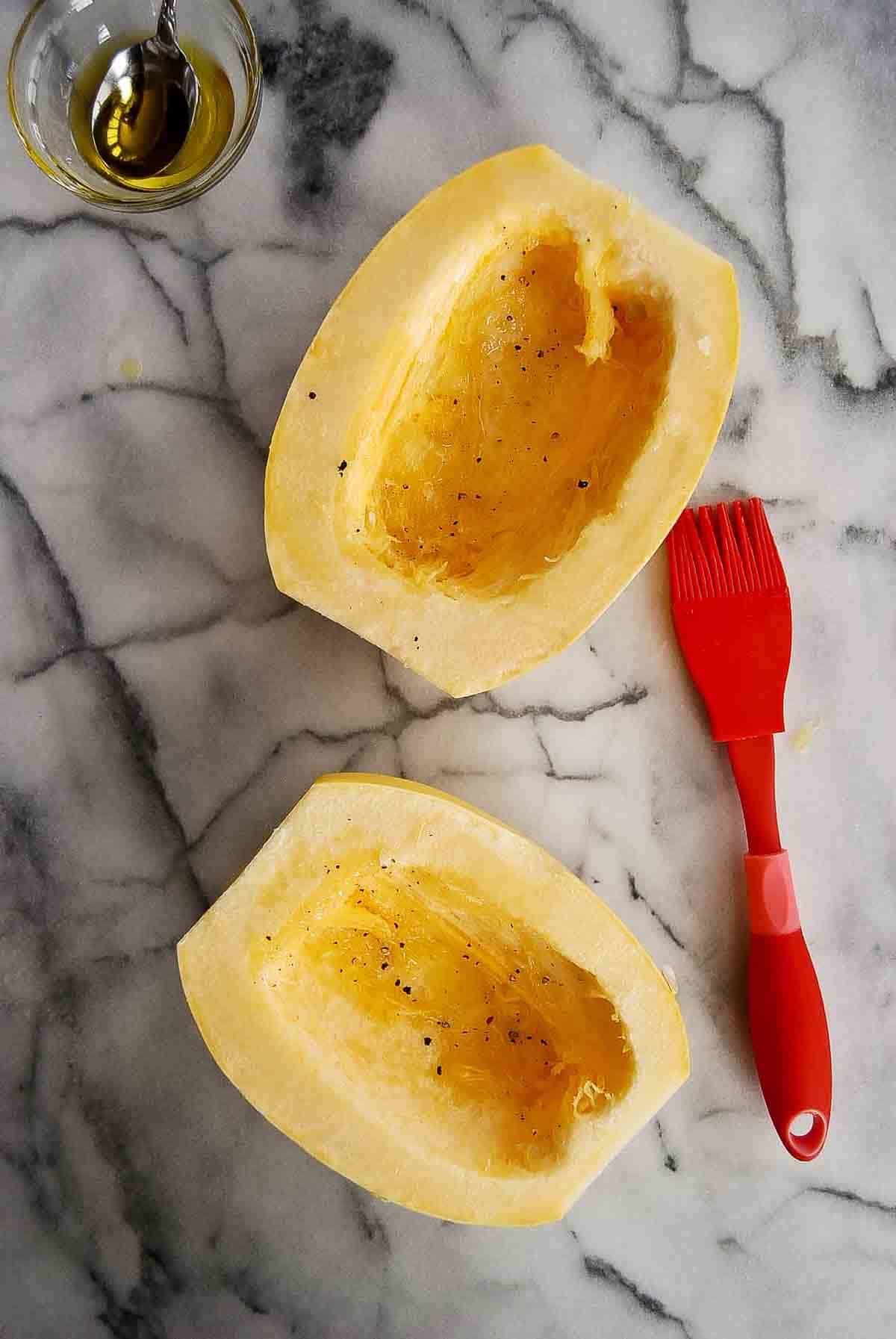 halves of spaghetti squash brushed with oil and sprinkled with salt and pepper.