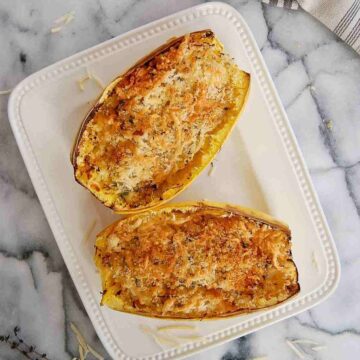 air fryer spaghetti squash with toasted cheese and breadcrumbs on top.