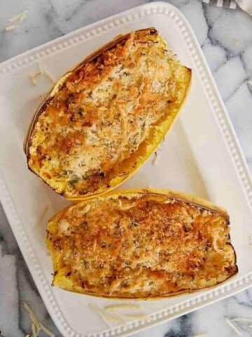 air fryer spaghetti squash with toasted cheese and breadcrumbs on top.