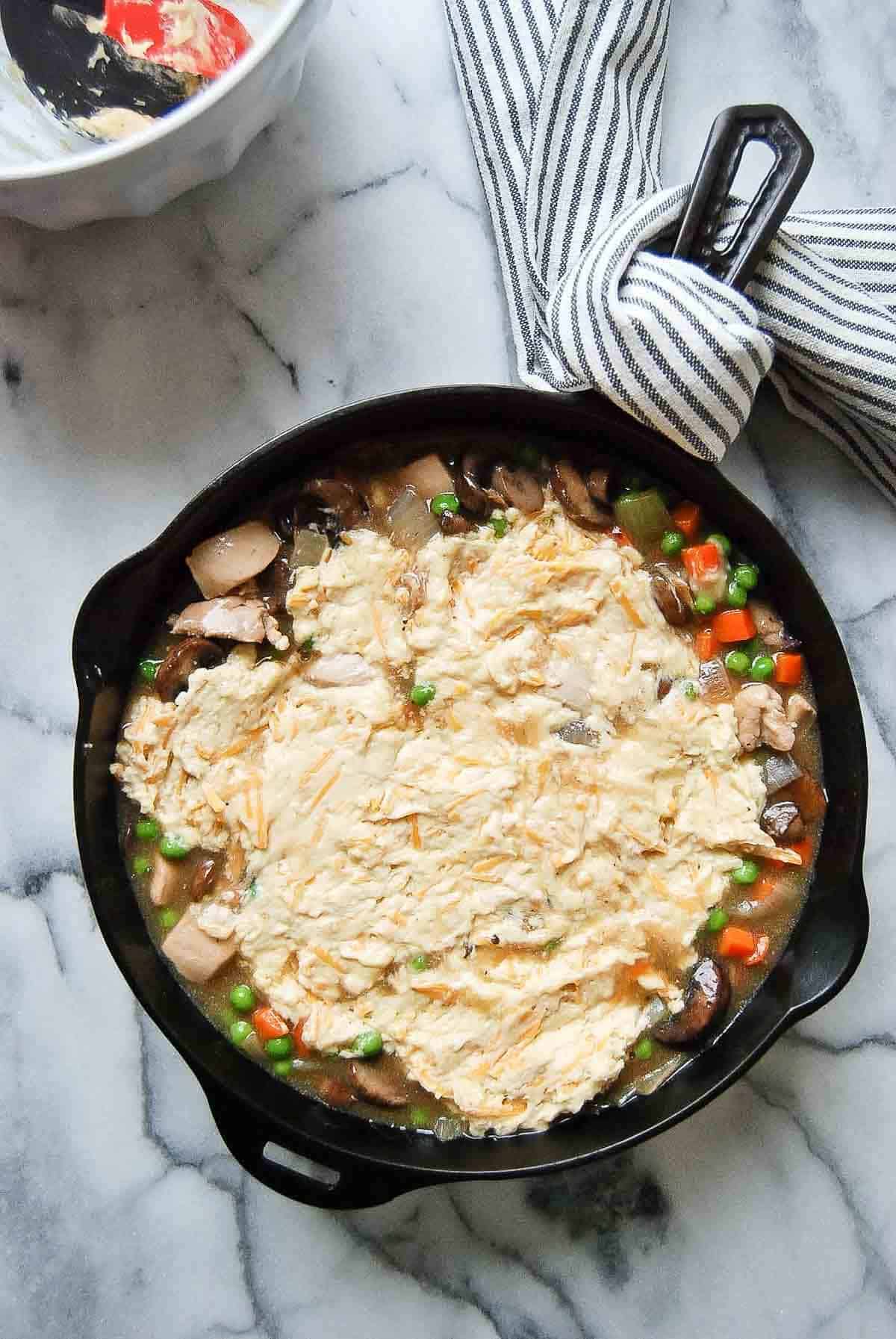 chicken cobbler with batter spread across the top.