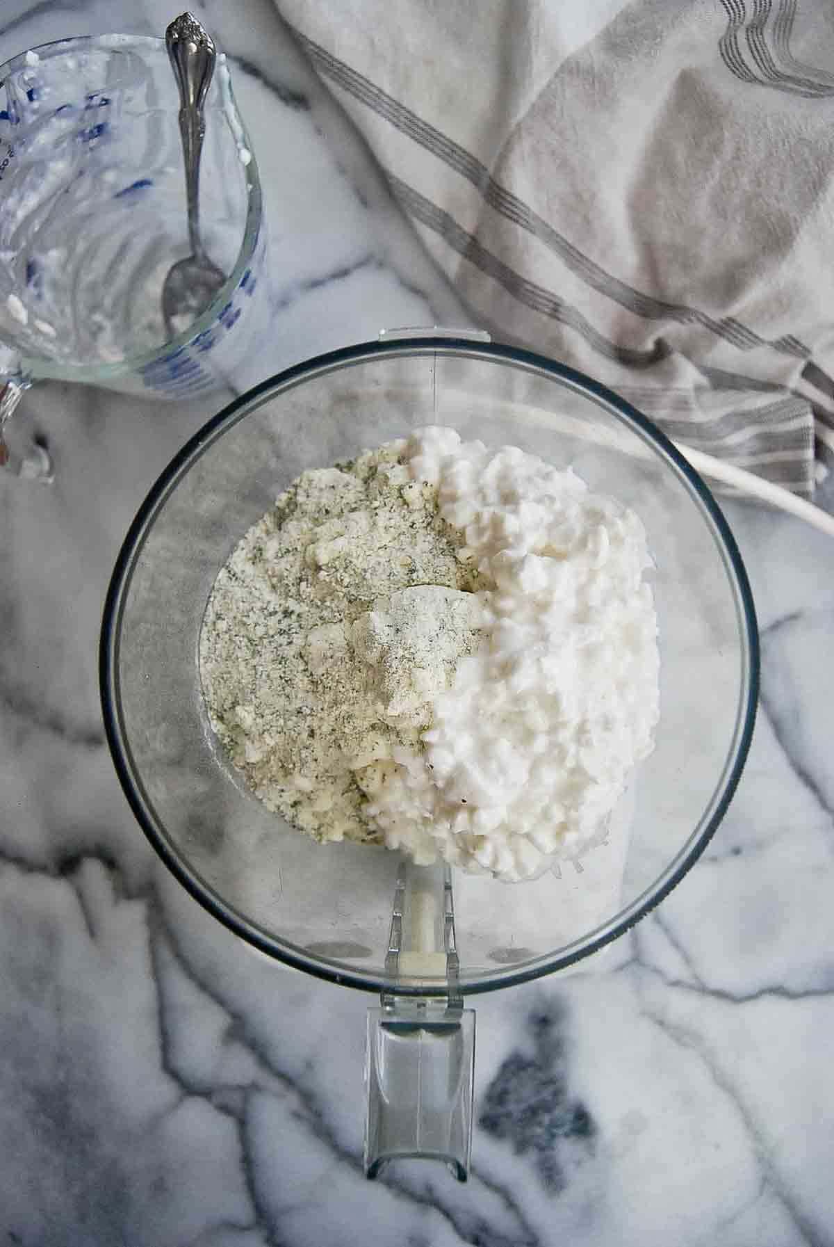 food processor with ranch mix and cottage cheese.