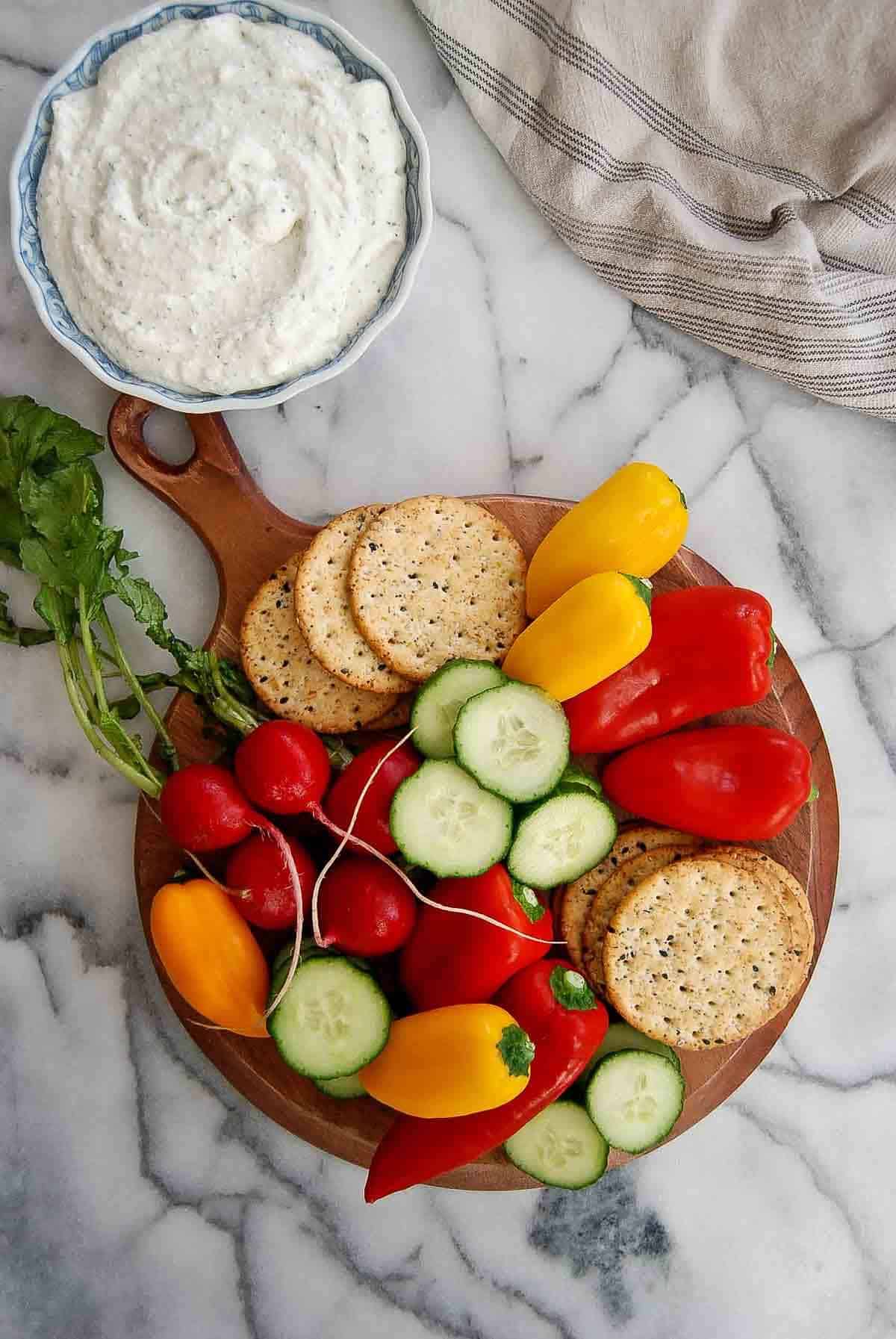 cottage cheese ranch dip with plate of veggies and crackers.
