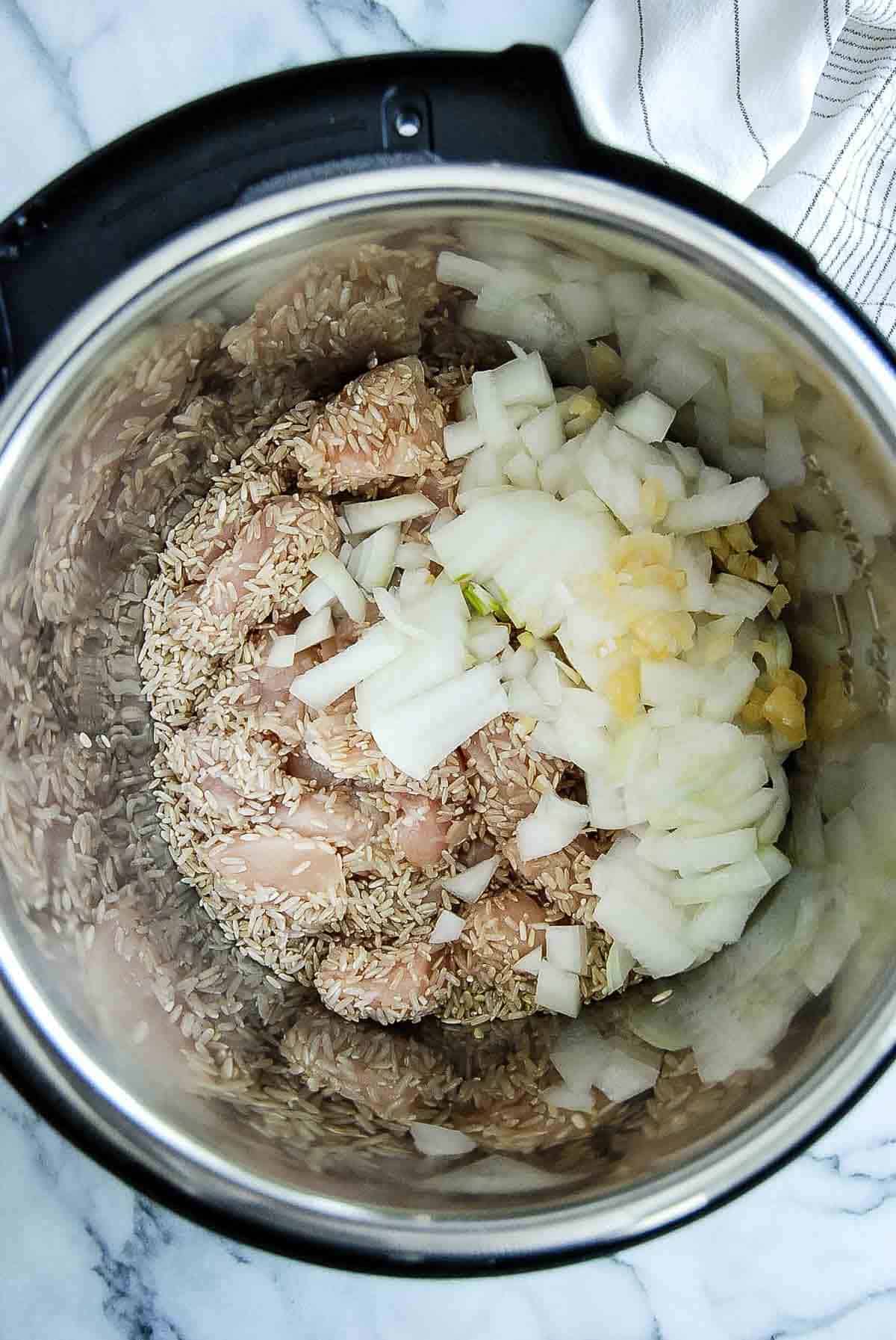 chicken rice, onion and garlic in crockpot.