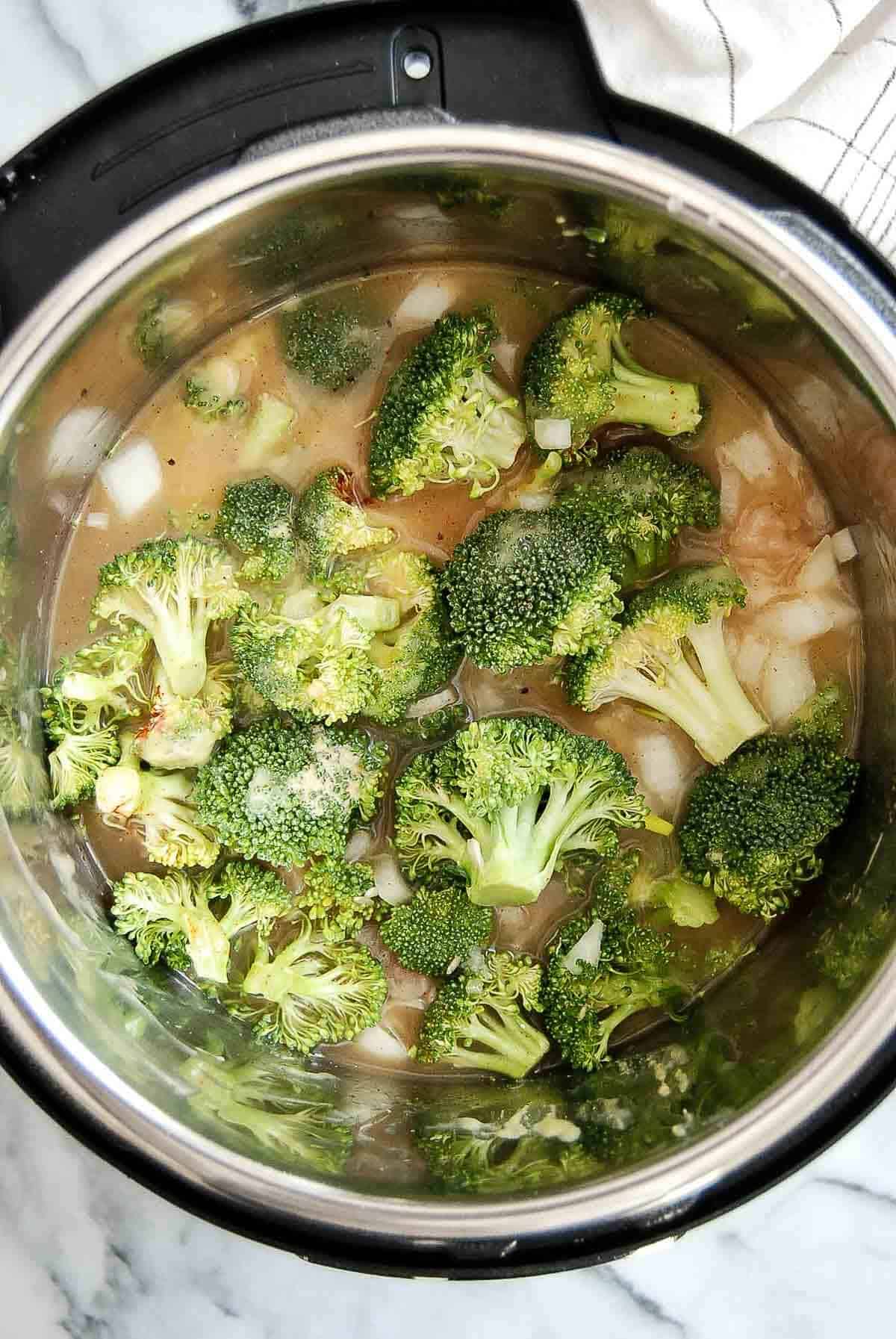 ingredients for chicken broccoli and rice casserole in crock pot.