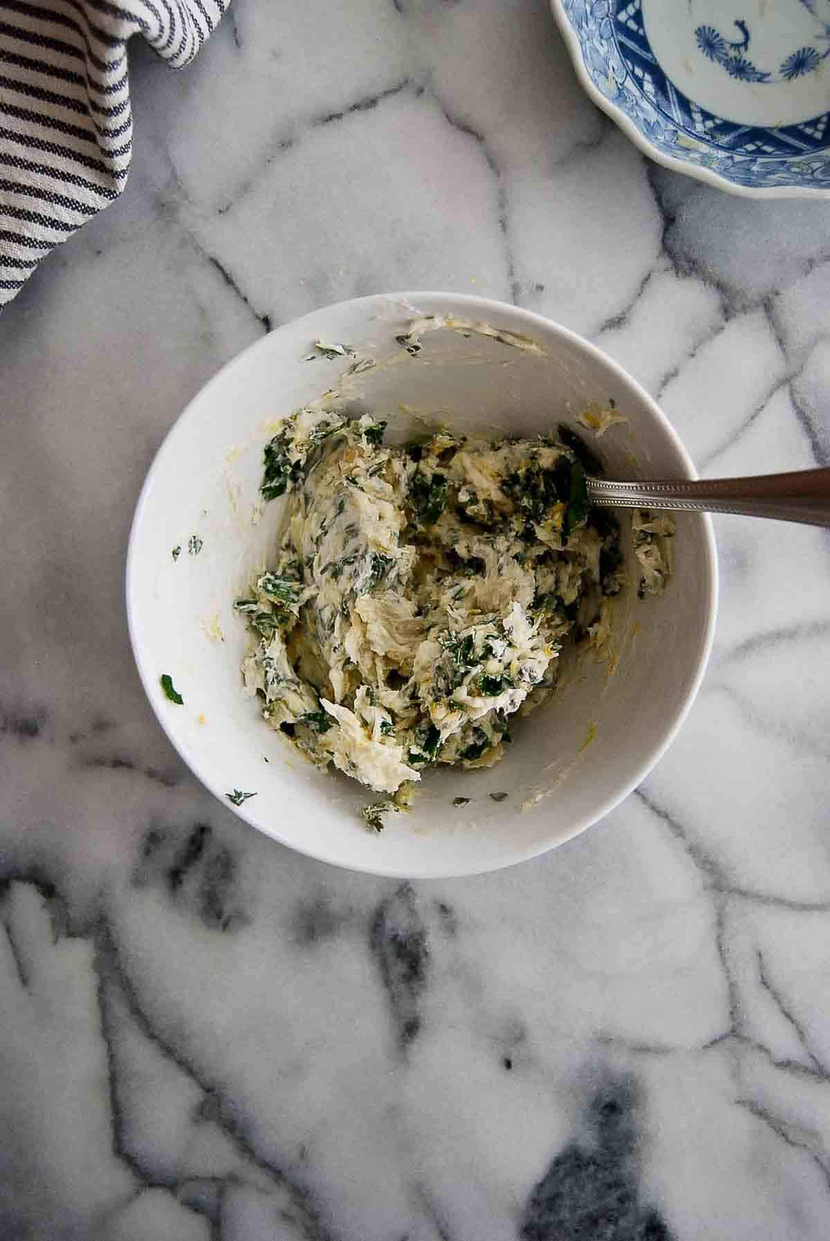 butter in bowl with garlic butter seasoning mixed in.