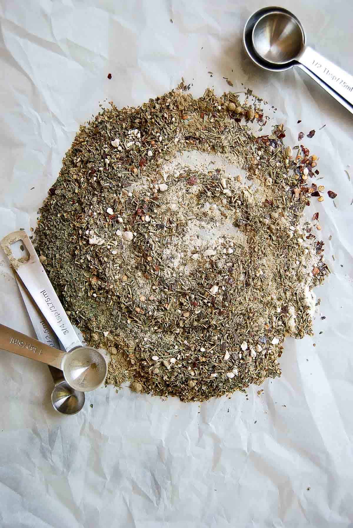 mixed seasoning for spaghetti sauce with measuring spoons on the side.