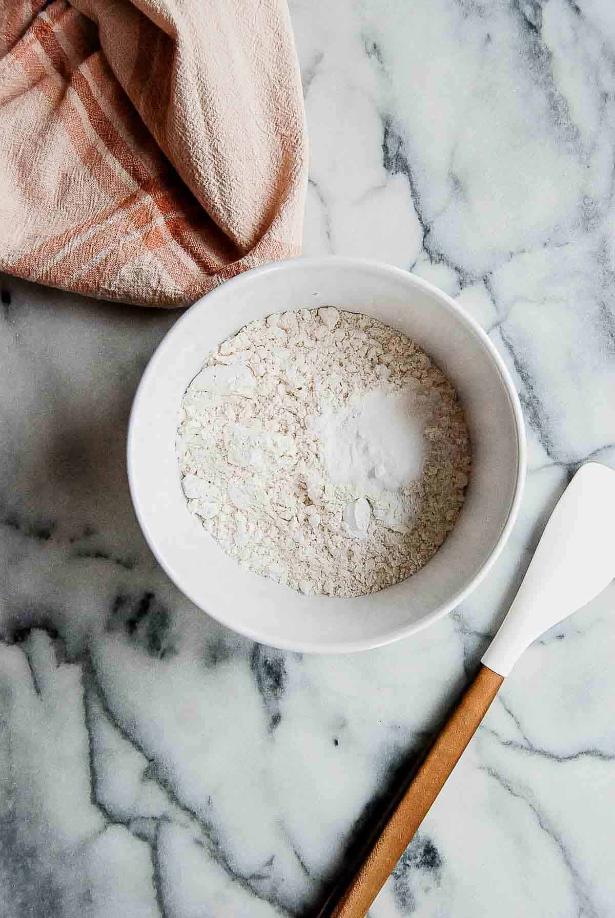 dry ingredients for chocolate chip cookies in bowl on countertop.