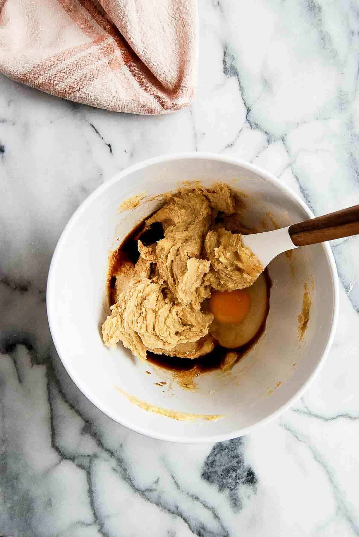 butter and sugar creamed in bowl with egg and vanilla added.