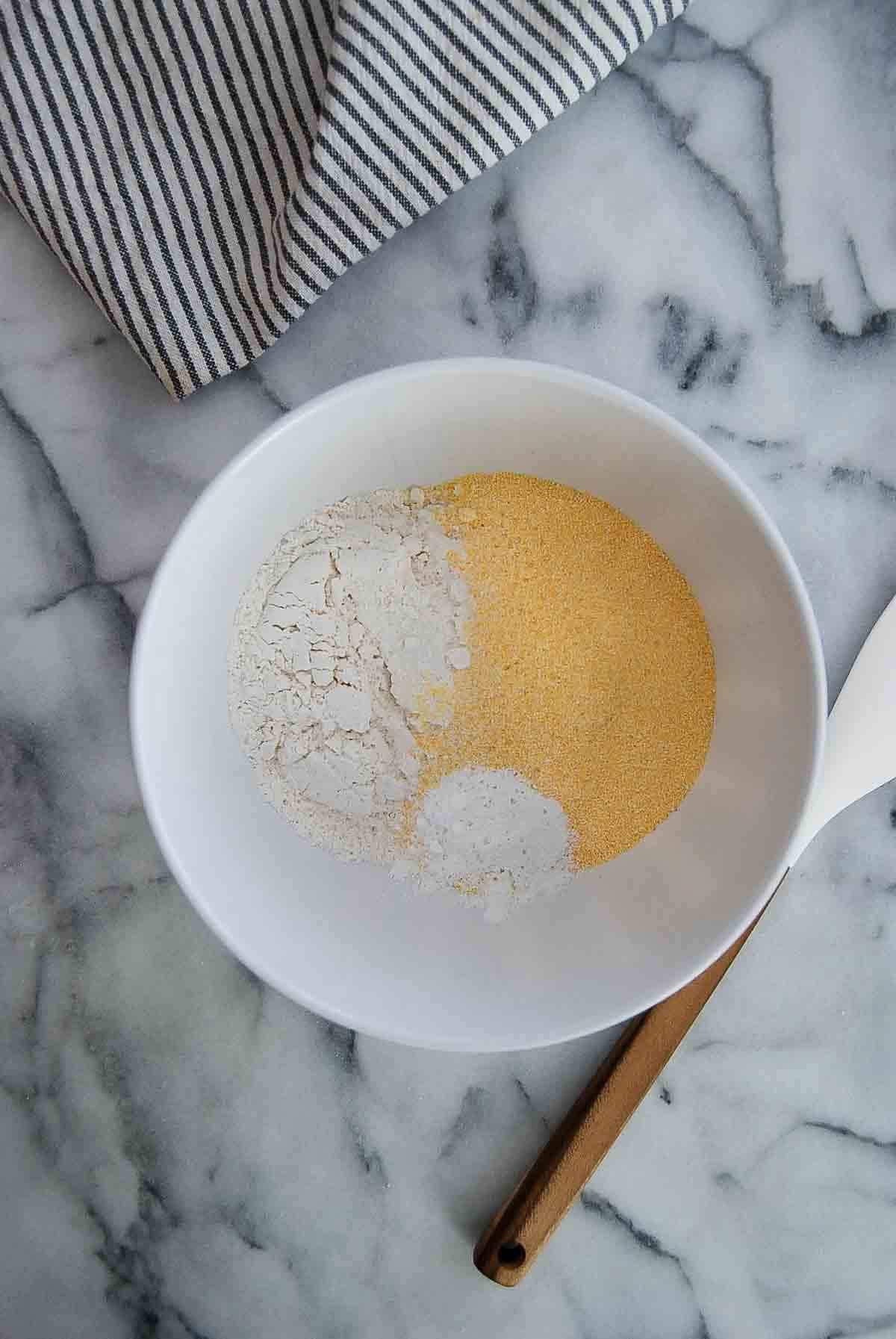 cornmeal, flour, baking powder and baking soda in mixing bowl.