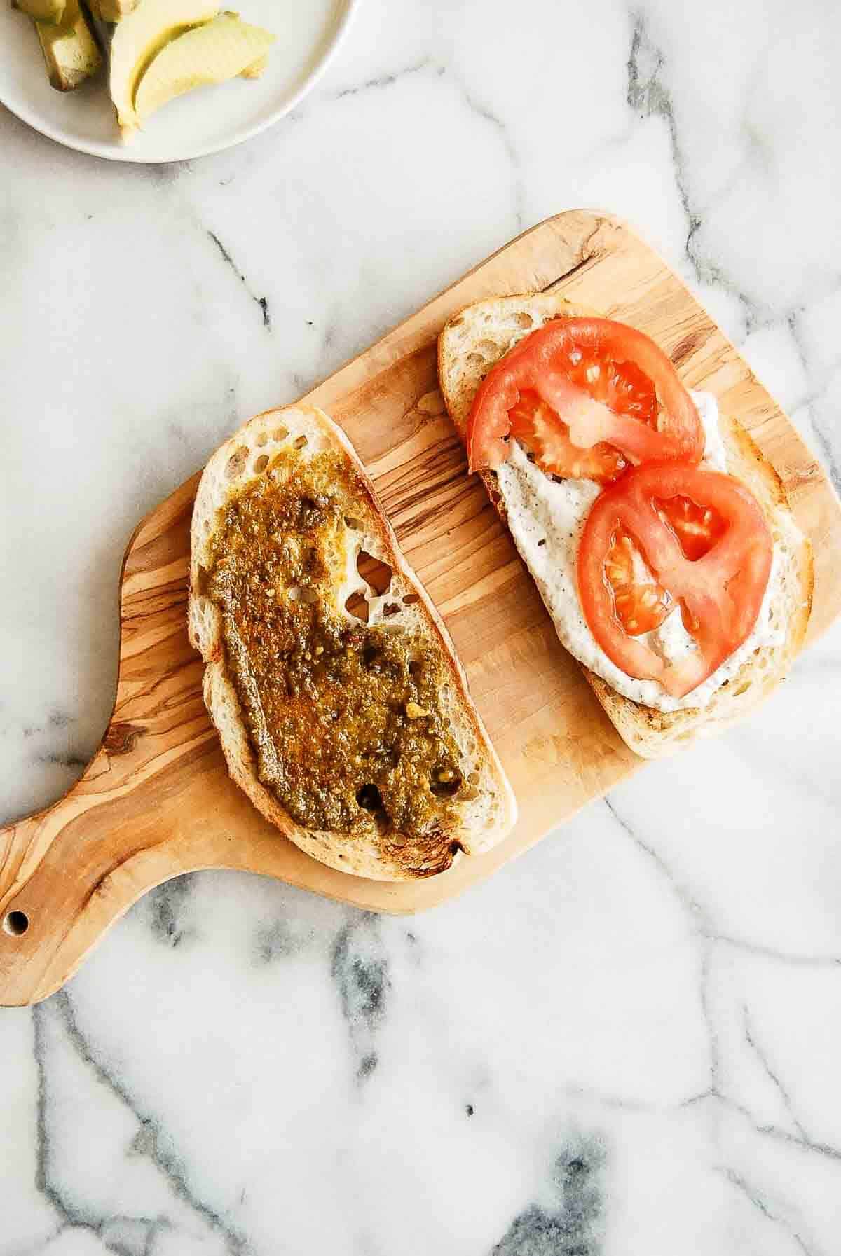 tunacado sandwich assembly on cutting board.