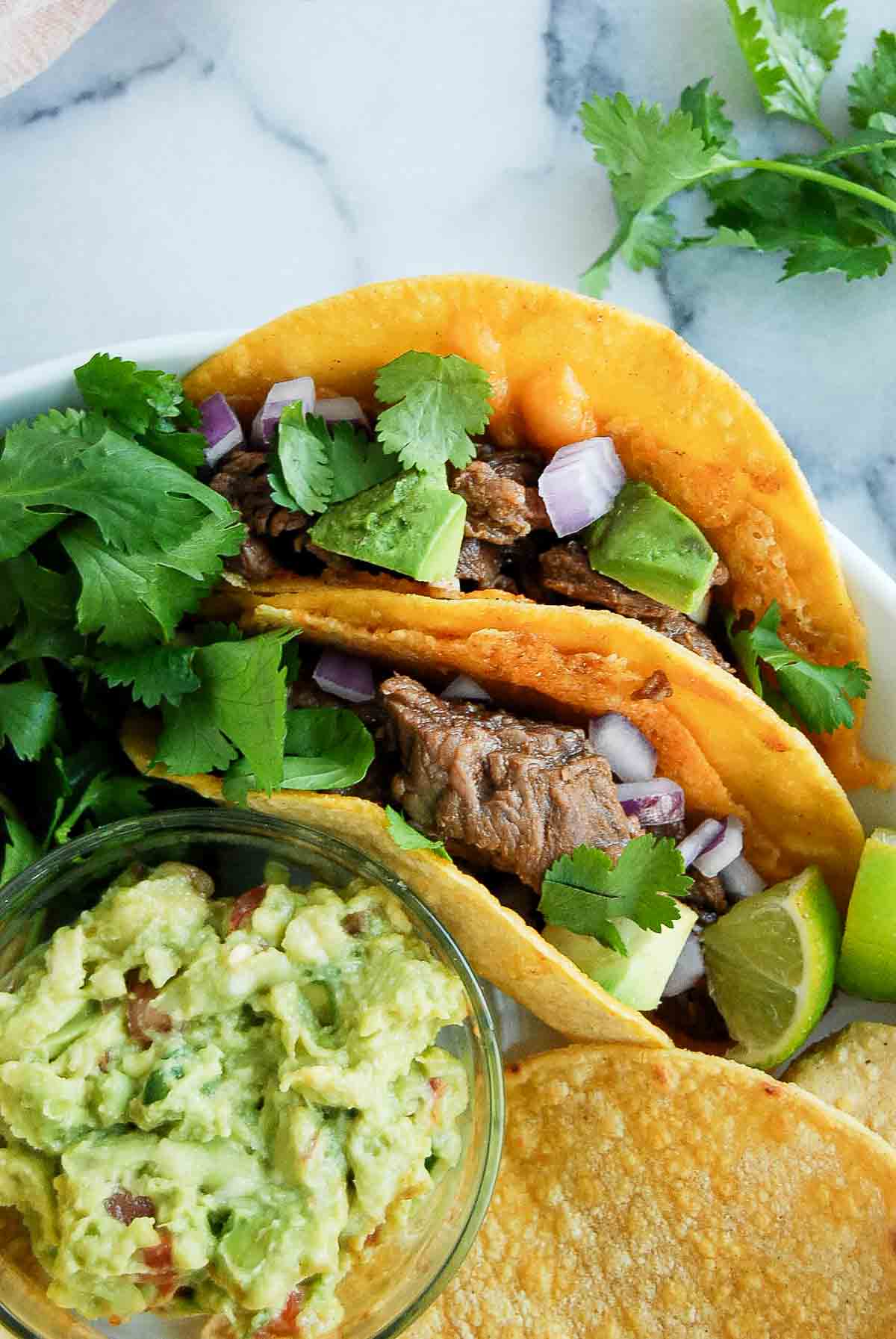 closeup of two vamprio tacos with carne asada.