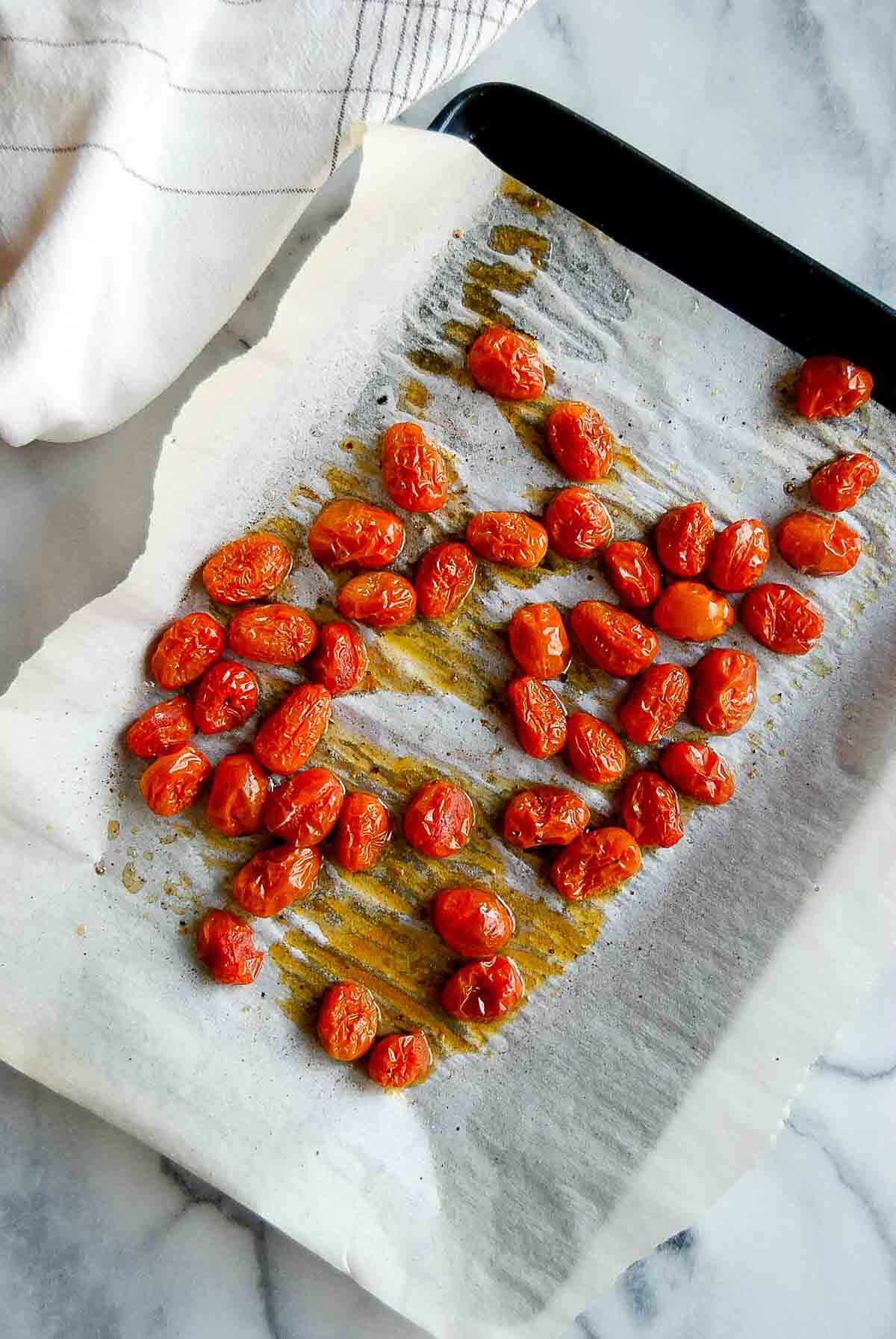 oven-roasted tomatoes on sheetpan.