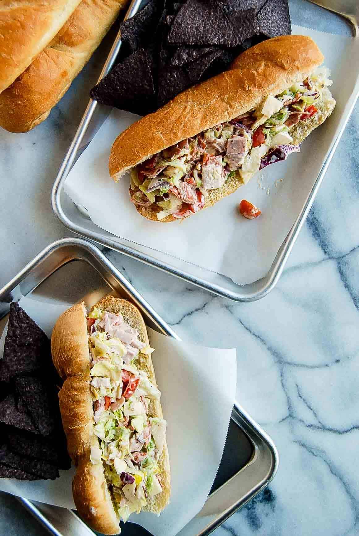 trays of italian chopped sandwiches on trays.