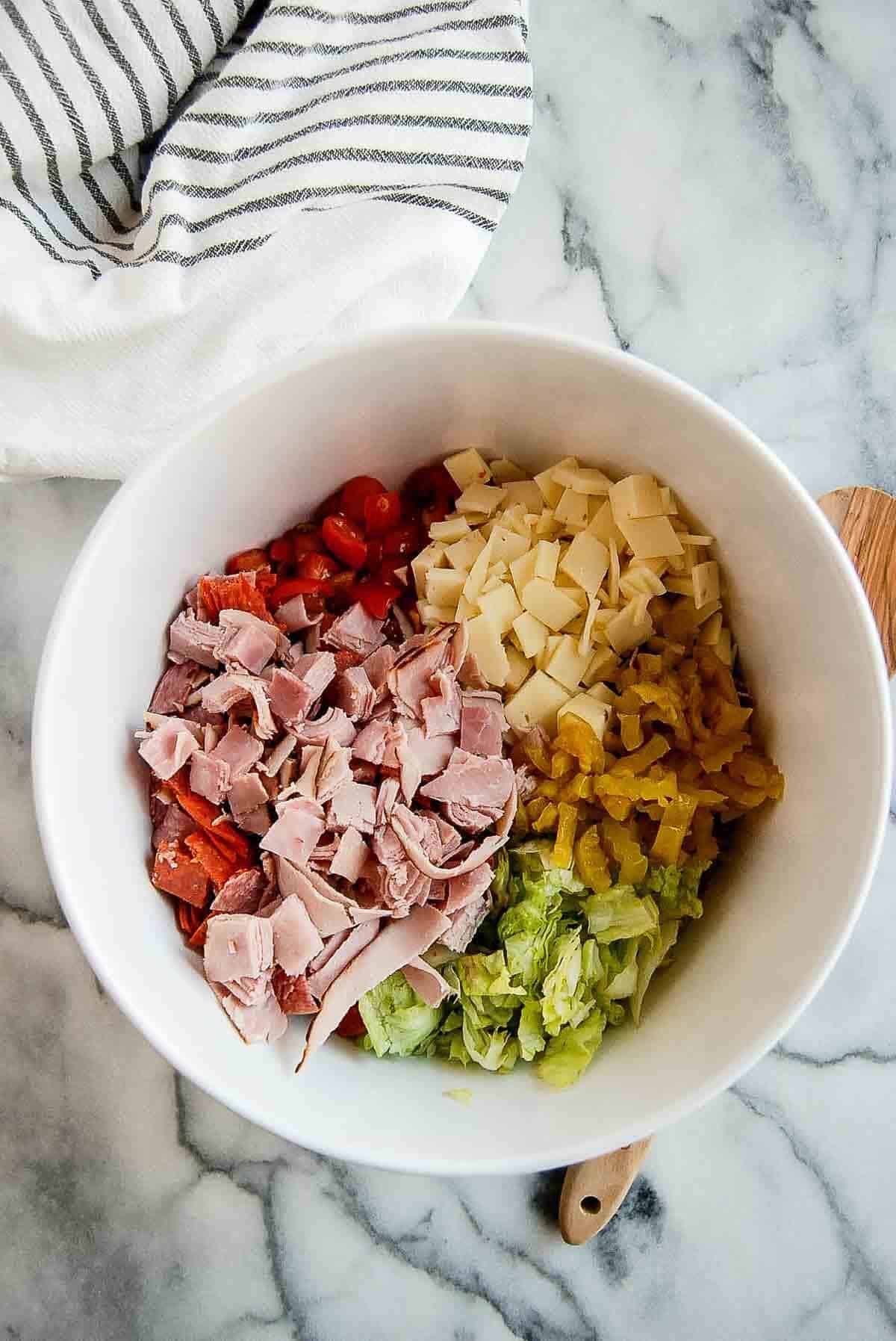 ingredients for chopped italian sandwiches in bowl.