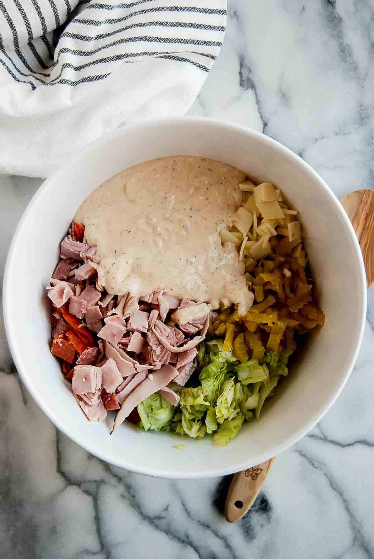 grinder salad ingredients with dressing added.