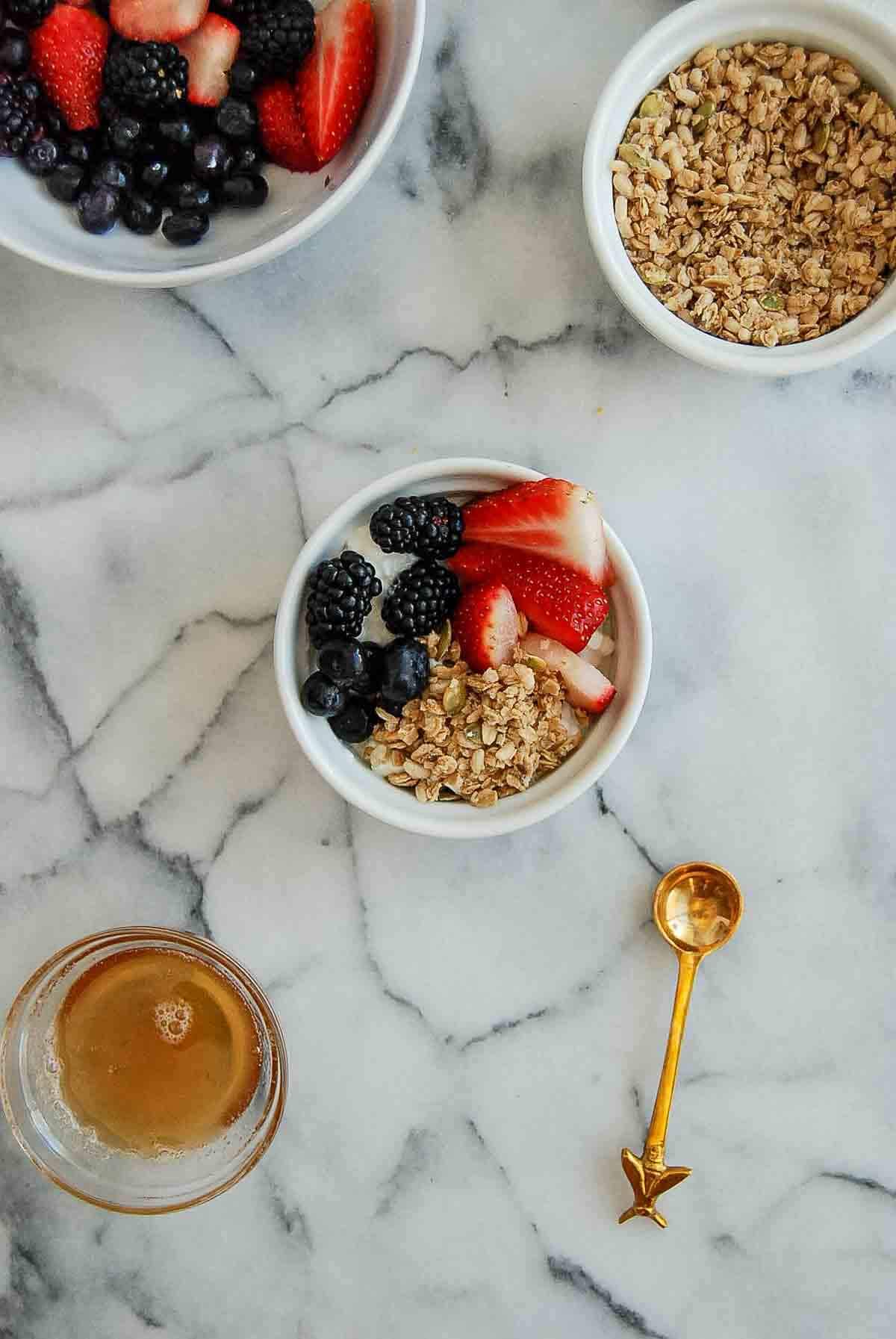 cottage cheese bowl, with fresh berries and granola on countertop.