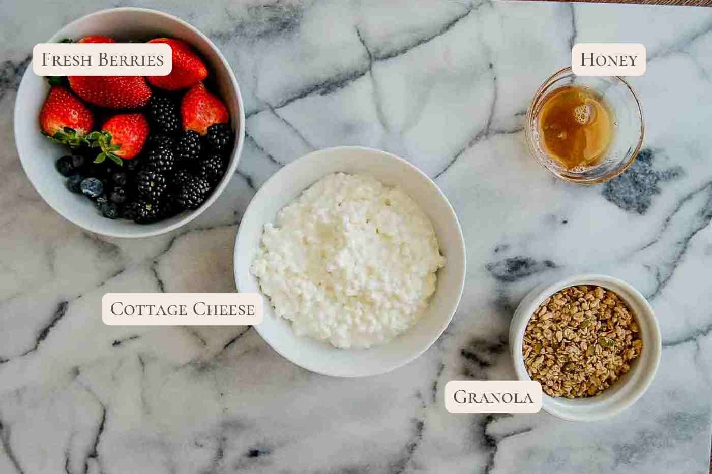 ingredients for cottage cheese with fruit bowl on countertop.