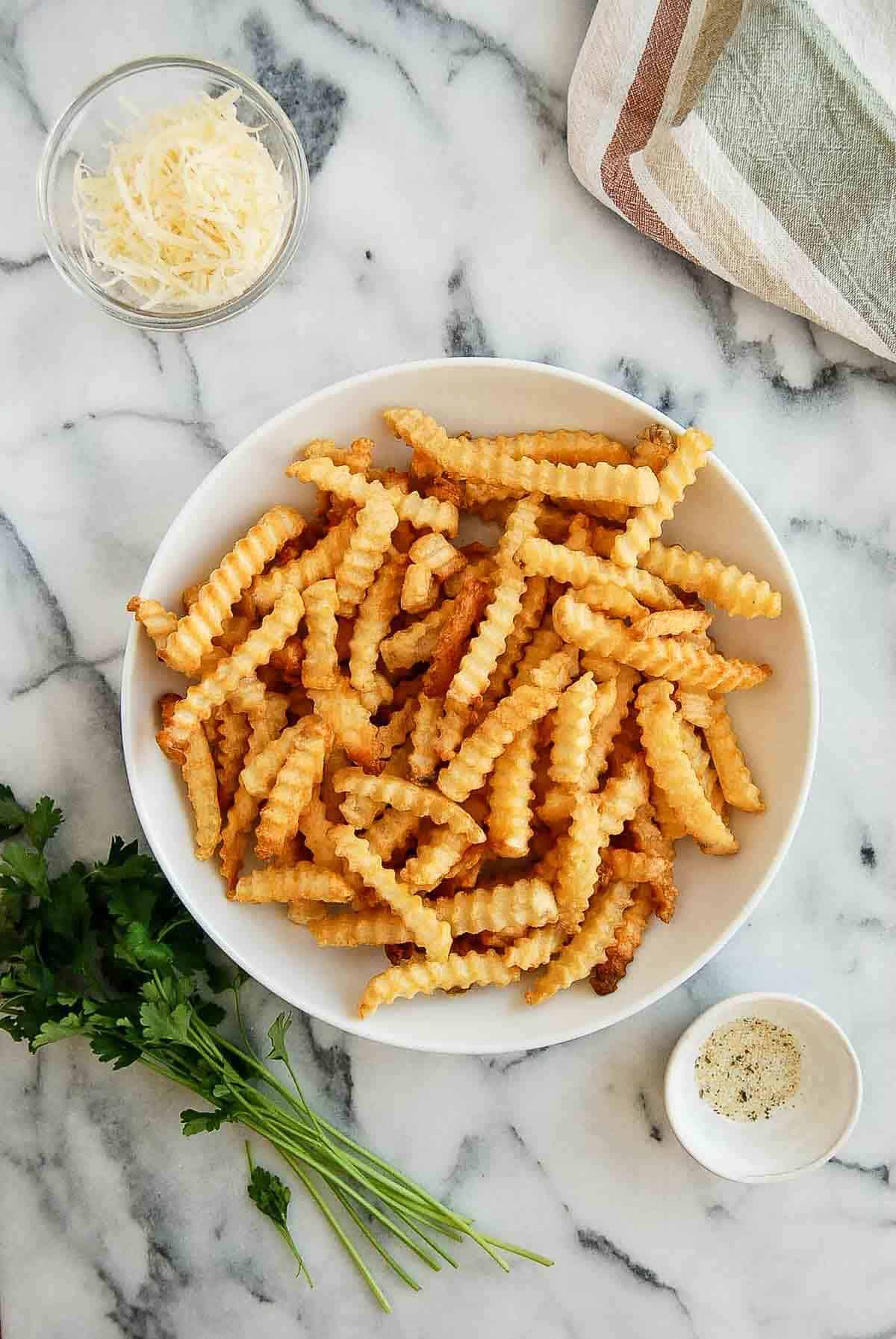 freshly fried air fryer french fries on countertop.