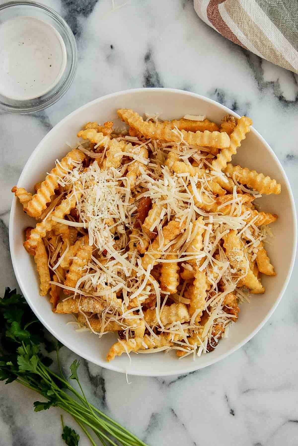 air-fried frozen french fries in bowl with parmesan cheese.