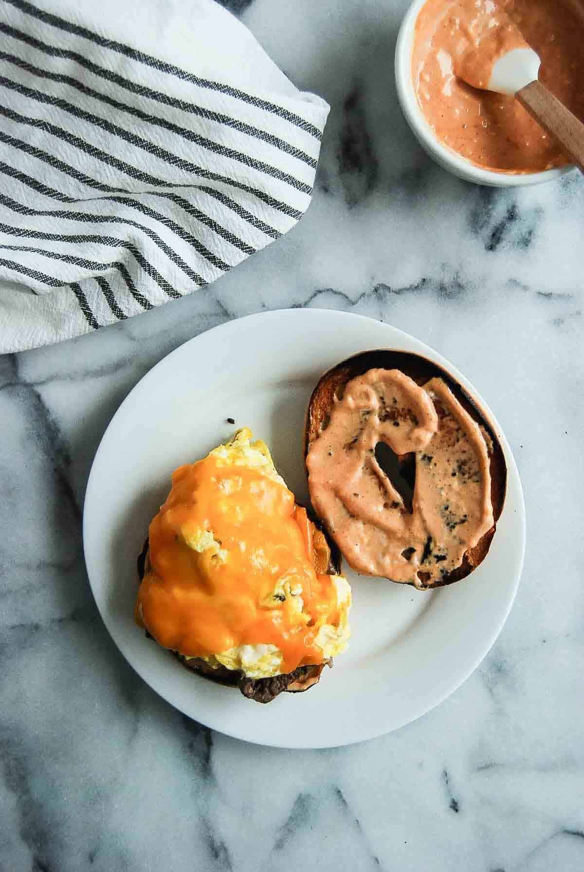 Bagel with breakfast sauce and egg and cheese.