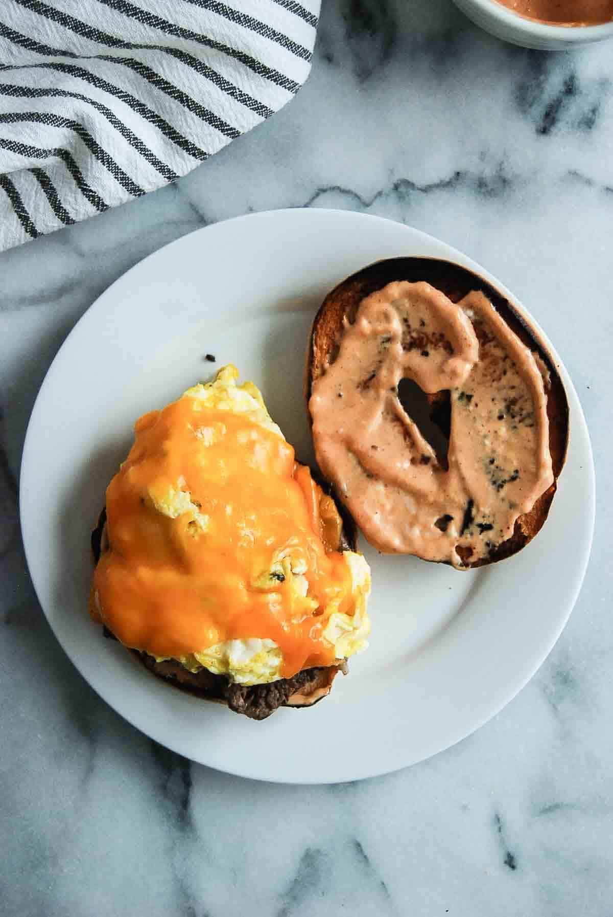 Bagel with breakfast sauce and egg and cheese.