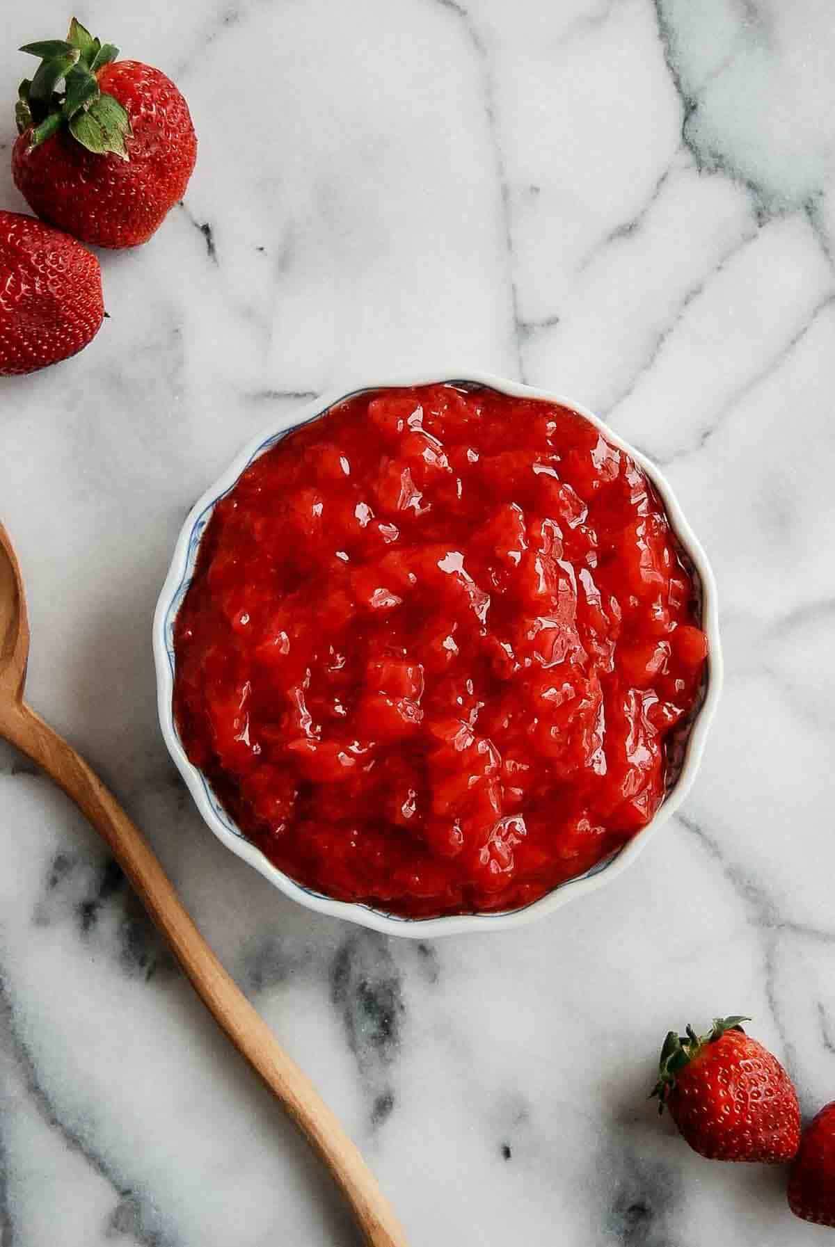 strawberry cake filling in bowl on countertop.