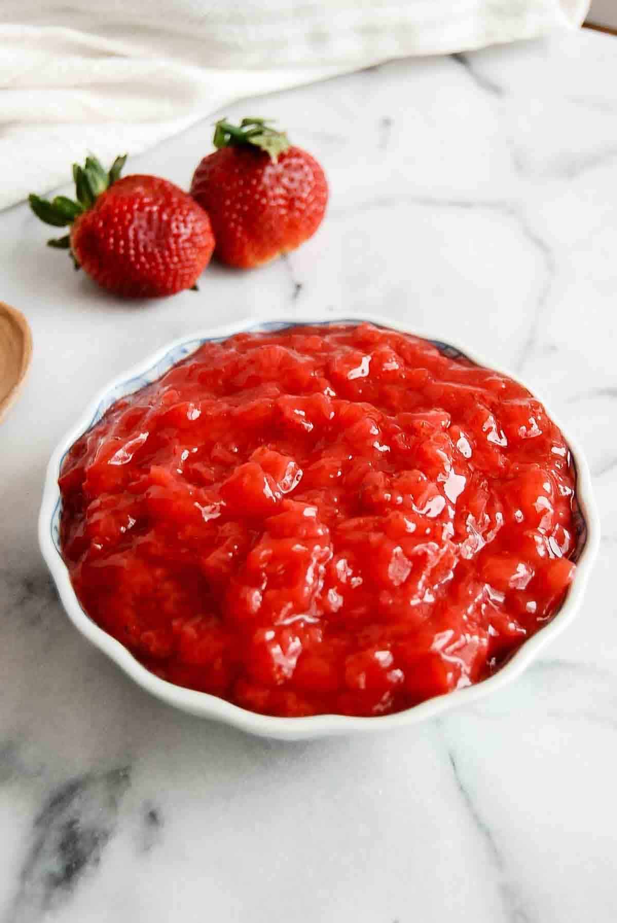 side view of strawberry cake filling in bowl.