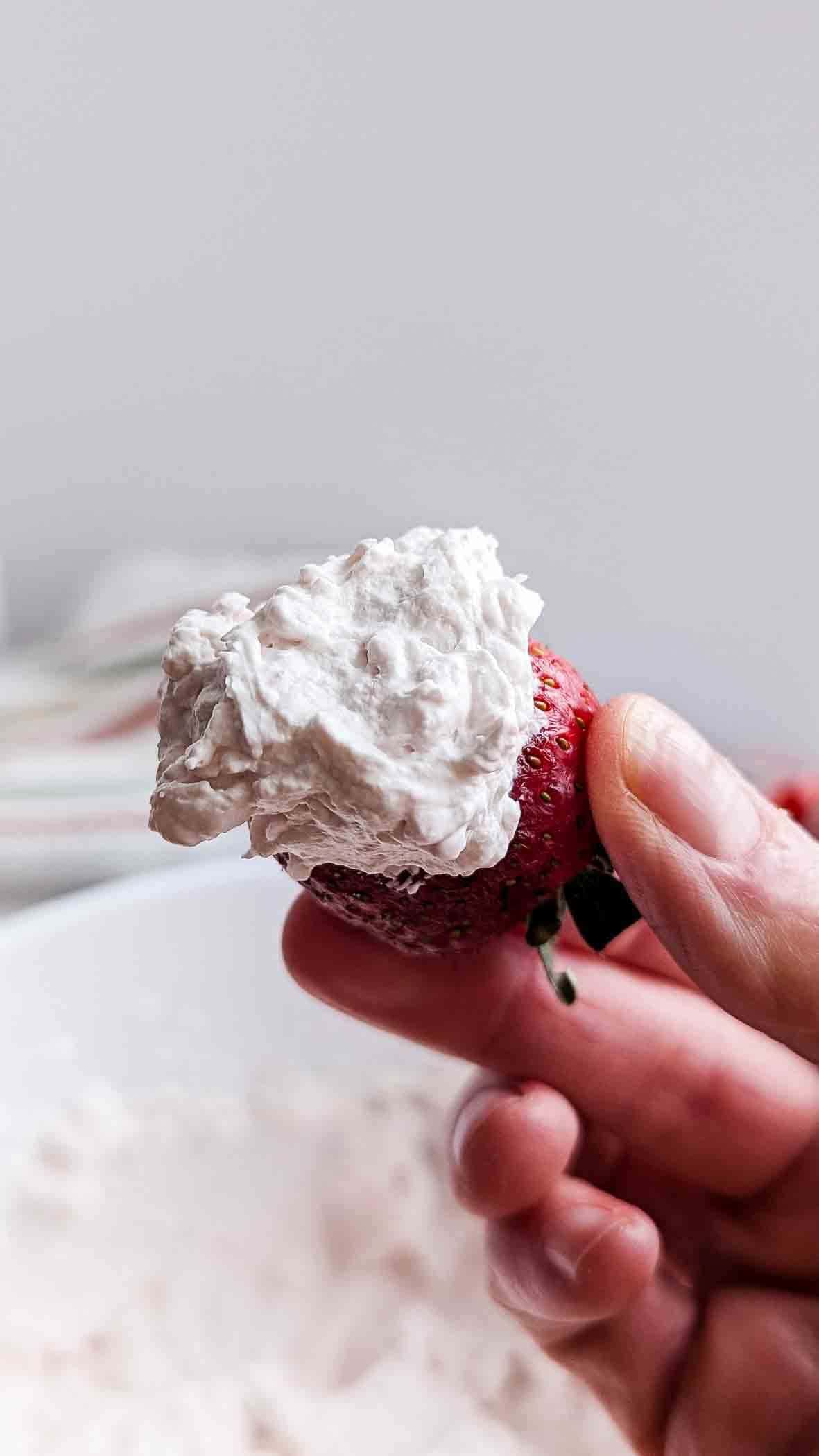 Strawberry dipped in whipped cream.