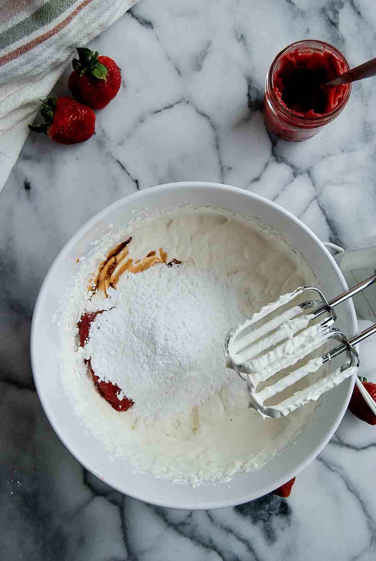 whipped cream with powdered sugar, strawberry puree and vanilla added.