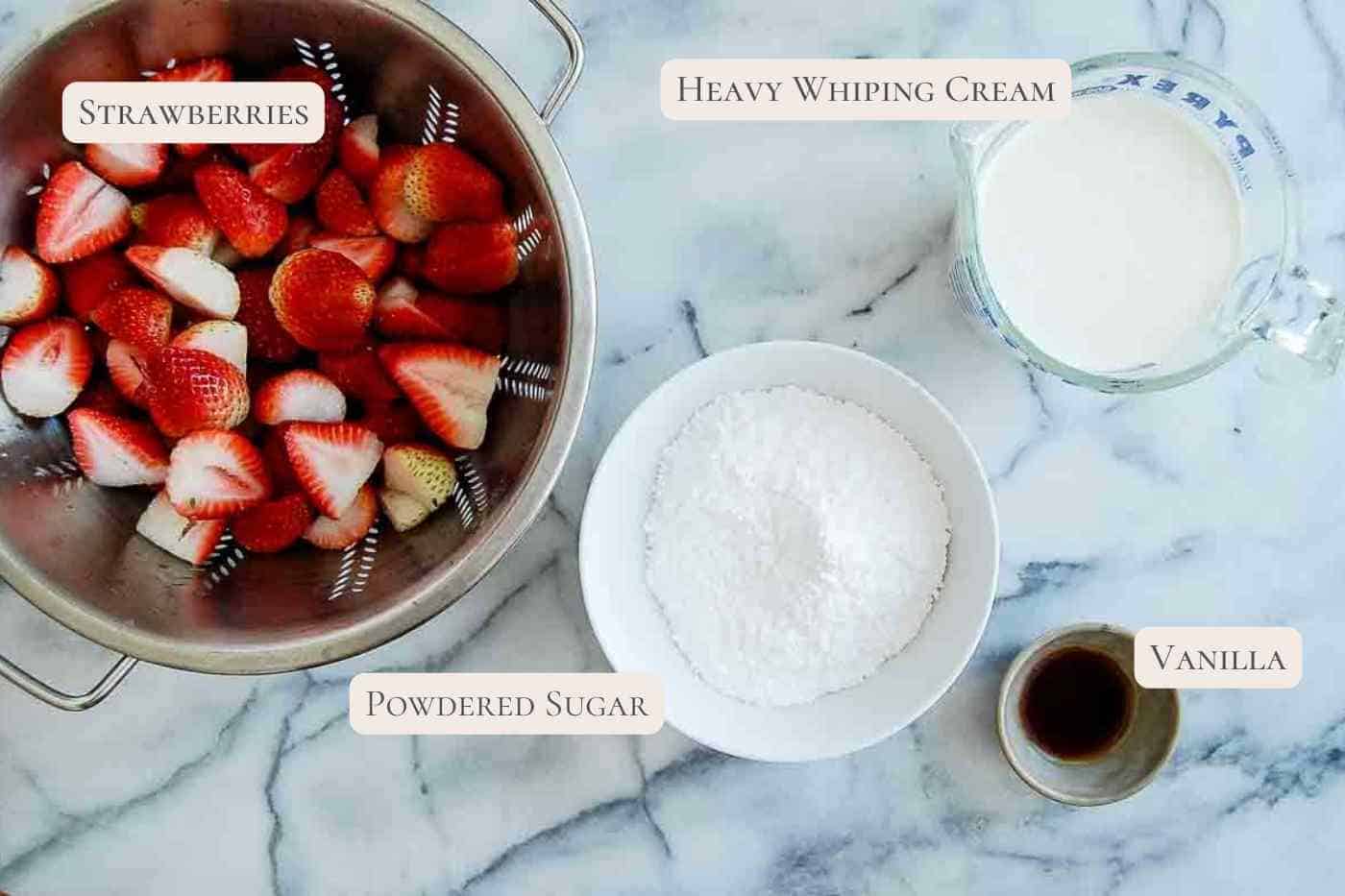 ingredients for strawberry whipped cream frosting on countertop.