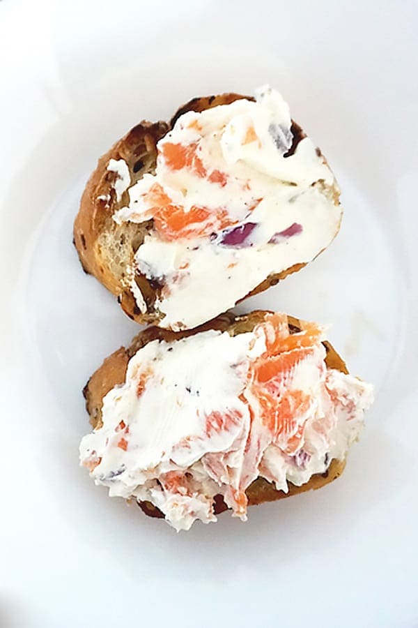 lox spread on to toast, on plate.