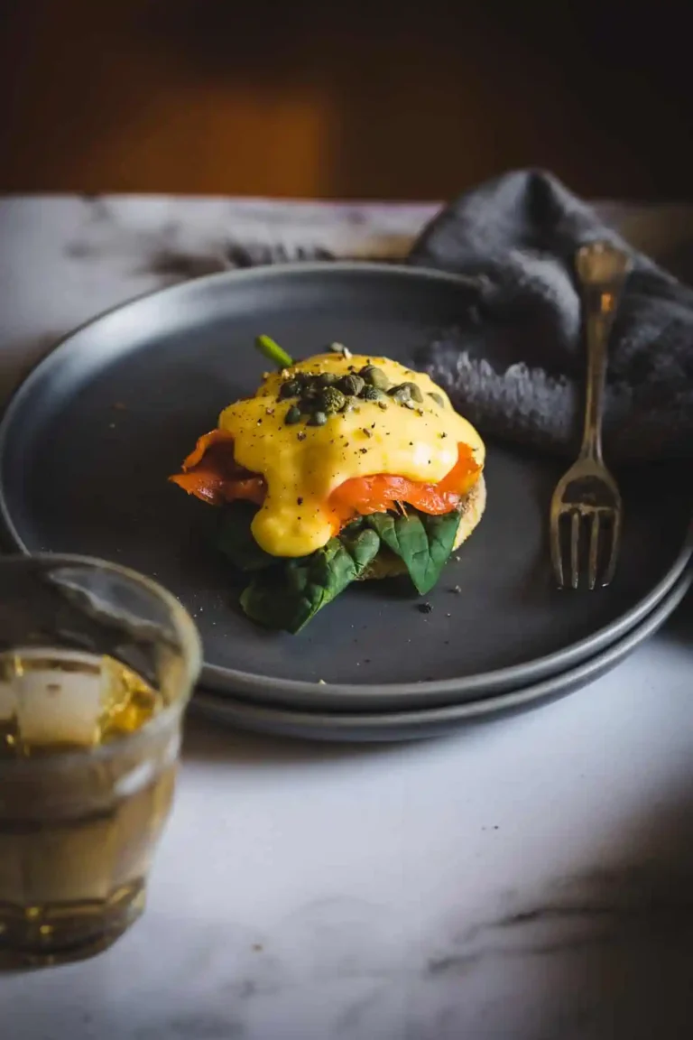 smoked salmon eggs benedict on plate.