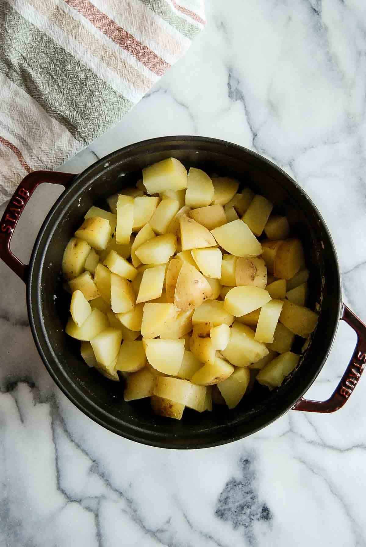 boiled yukon gold potatoes in pot.