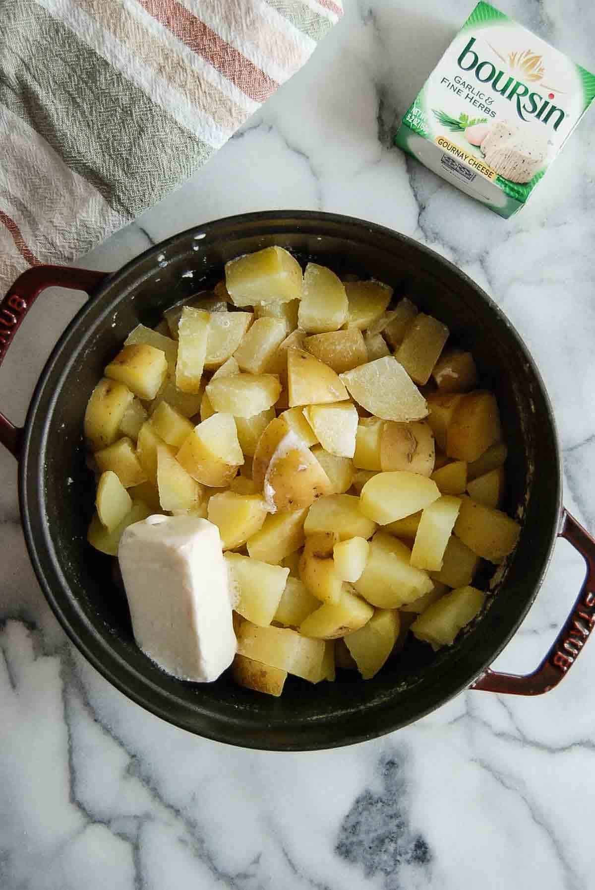 boiled yukon gold potatoes in pot with butter.