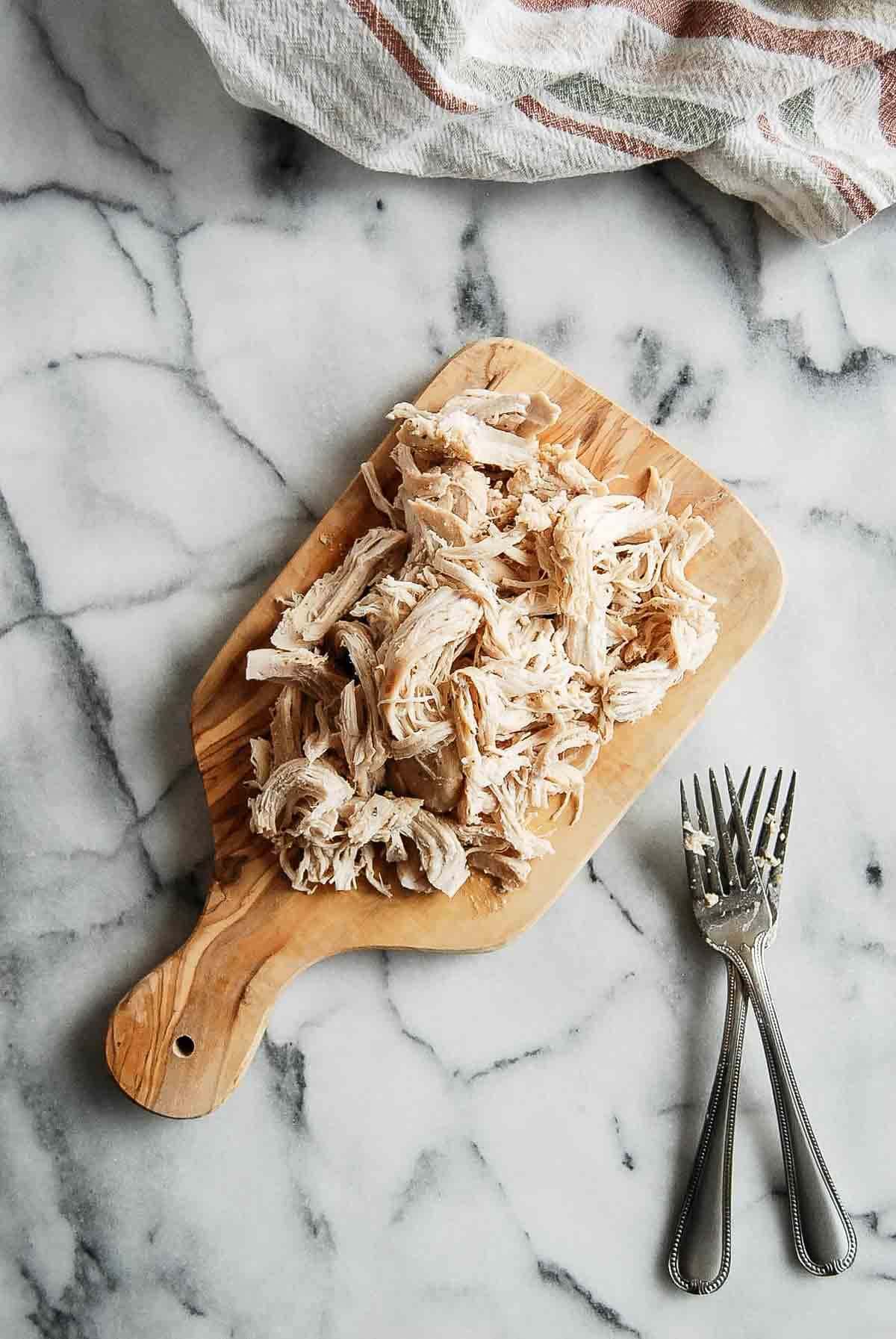 shredded chicken on cutting board.