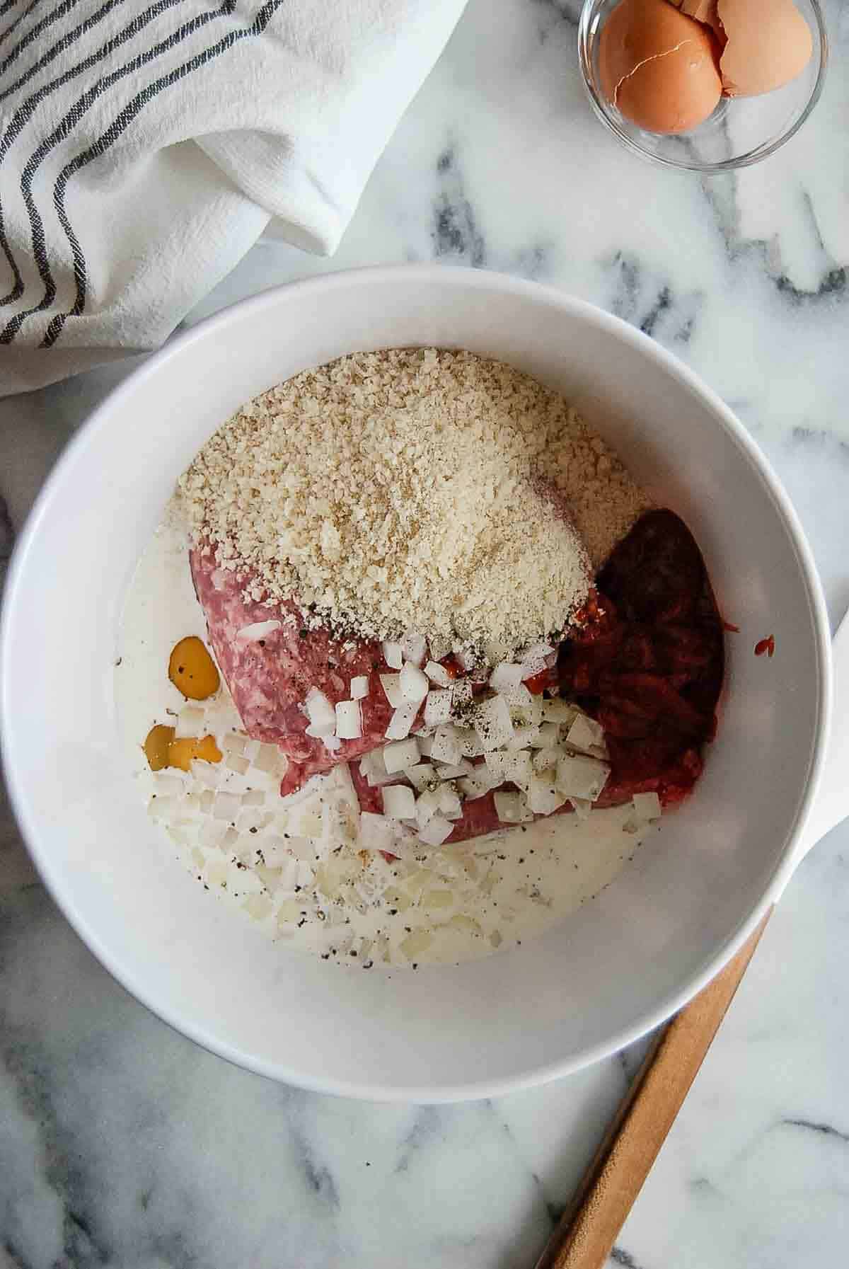 ingredients for meatloaf in mixing bowl.