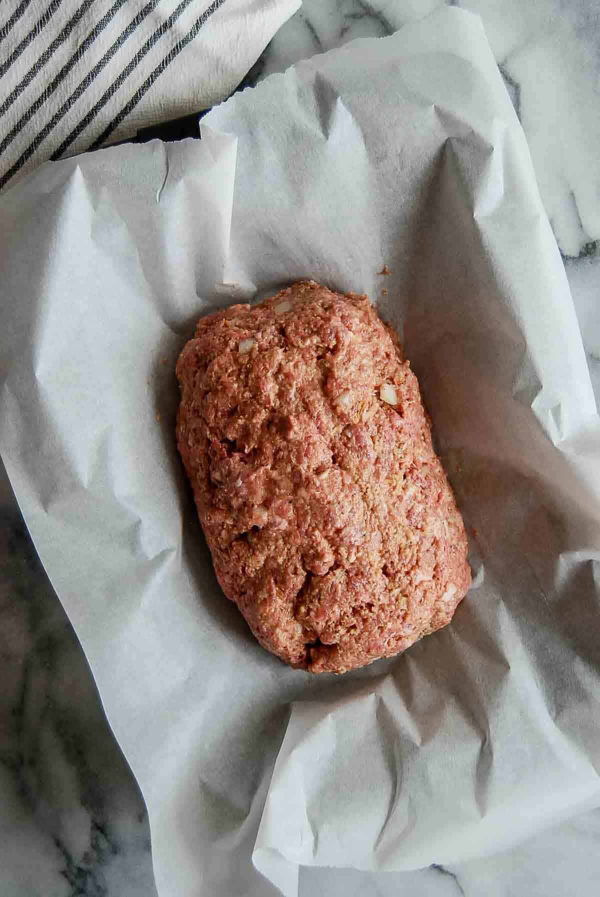 formed meatloaf in pan, ready for baking.