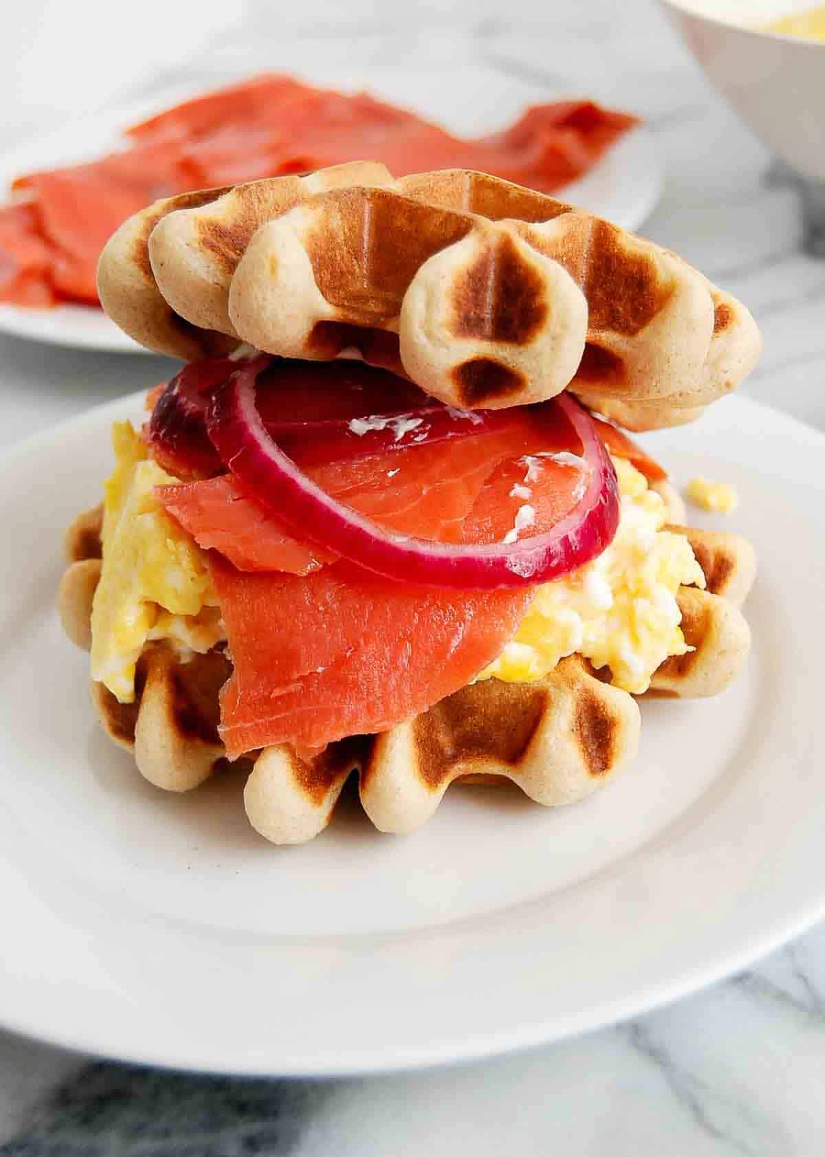 waffle breakfast sandwich on plate.