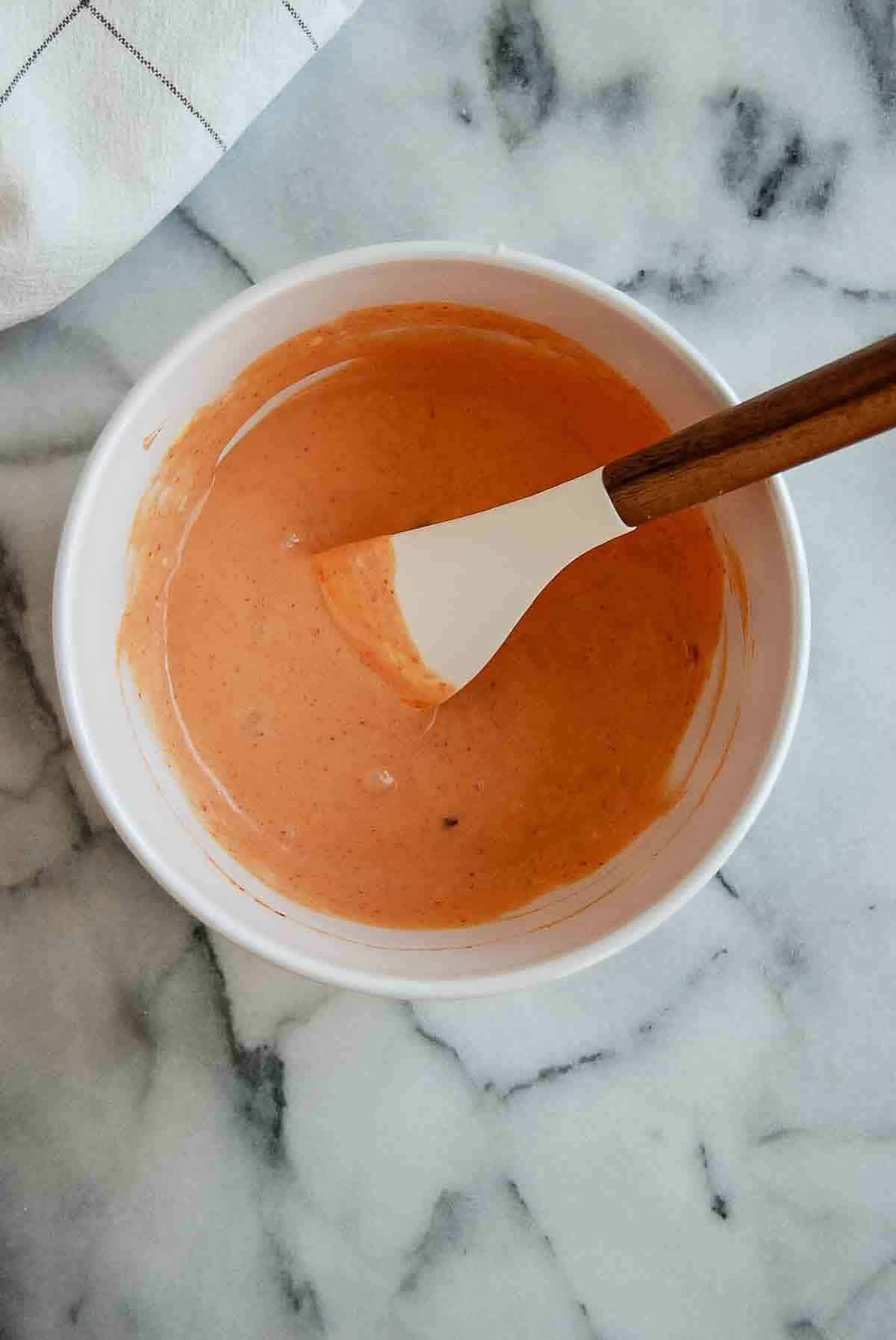 mixed boom boom sauce in bowl on countertop.