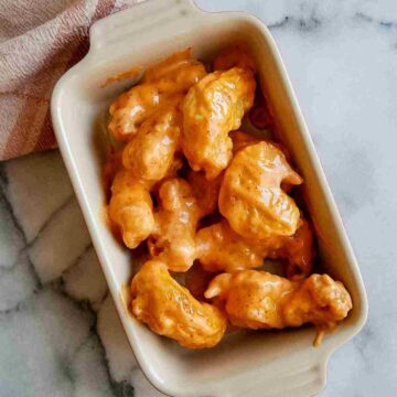 closeup of tempura shrimp in serving bowl on countertop.