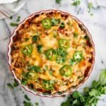 baked chicken tamale pie with cilantro and jalapeno slices on top.