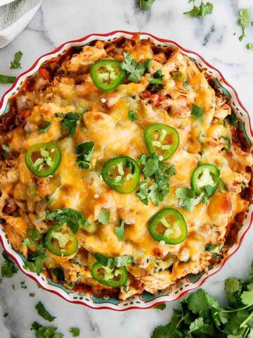 baked chicken tamale pie with cilantro and jalapeno slices on top.