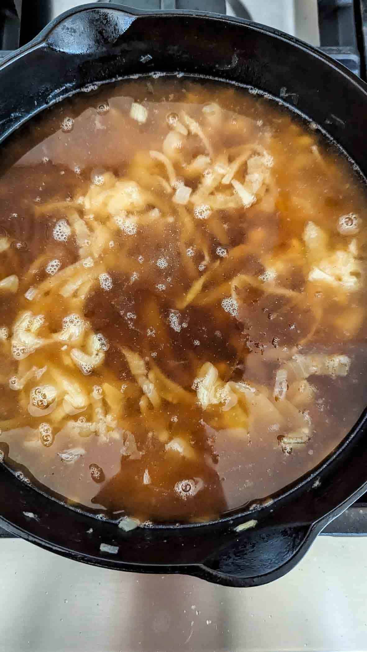 caramelized onions in pot with beef broth.