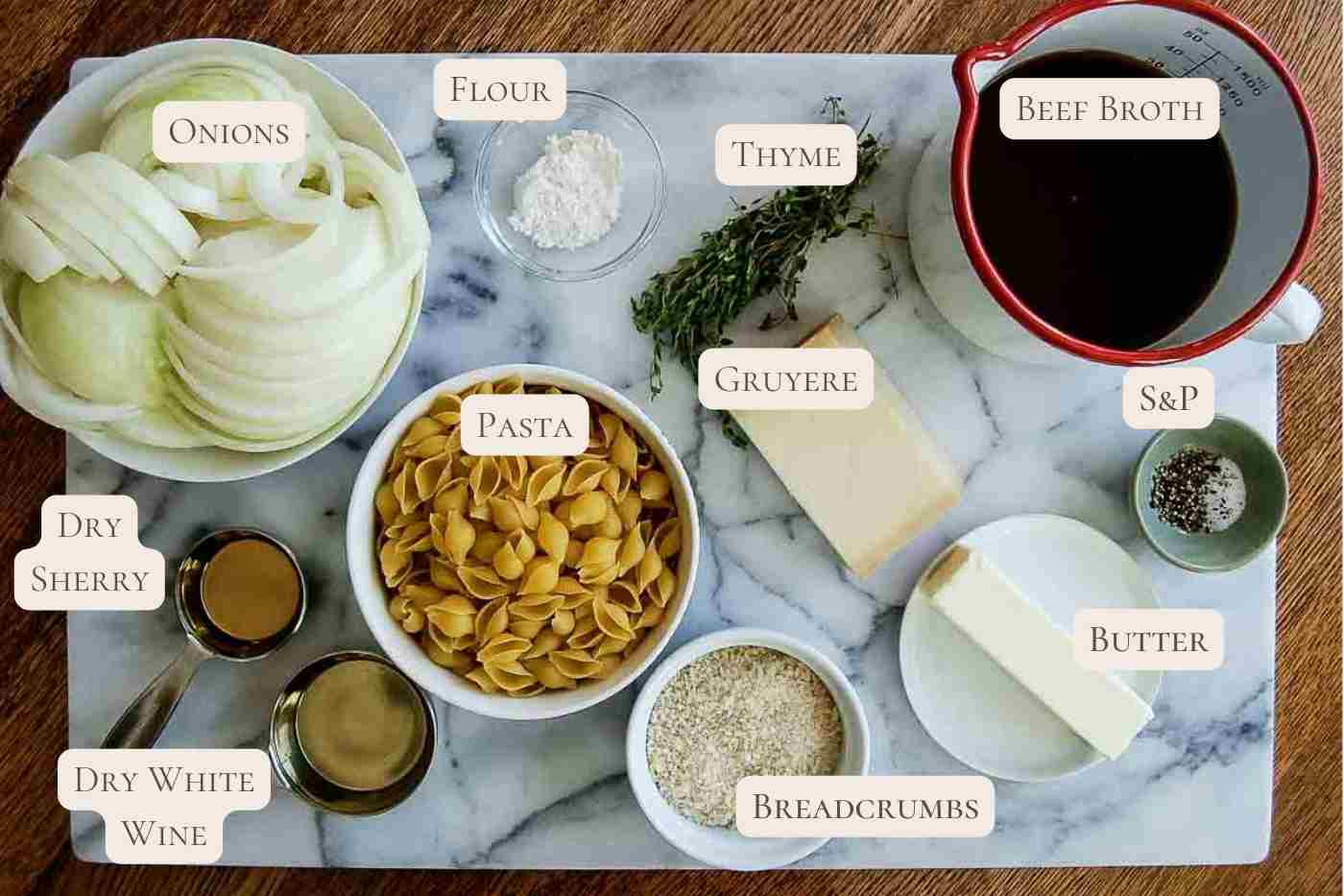 ingredients for french onion soup pasta on cutting board.