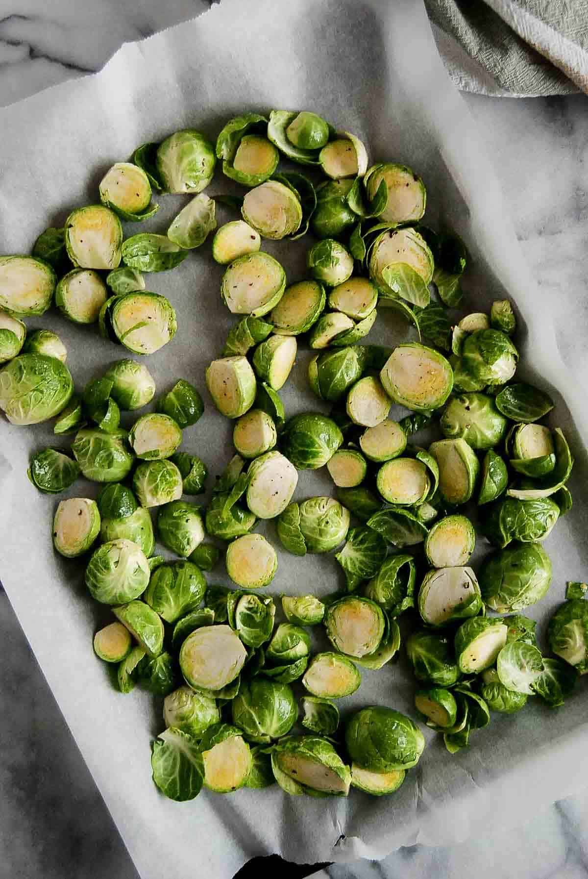 brussels sprouts with oil on baking sheet.