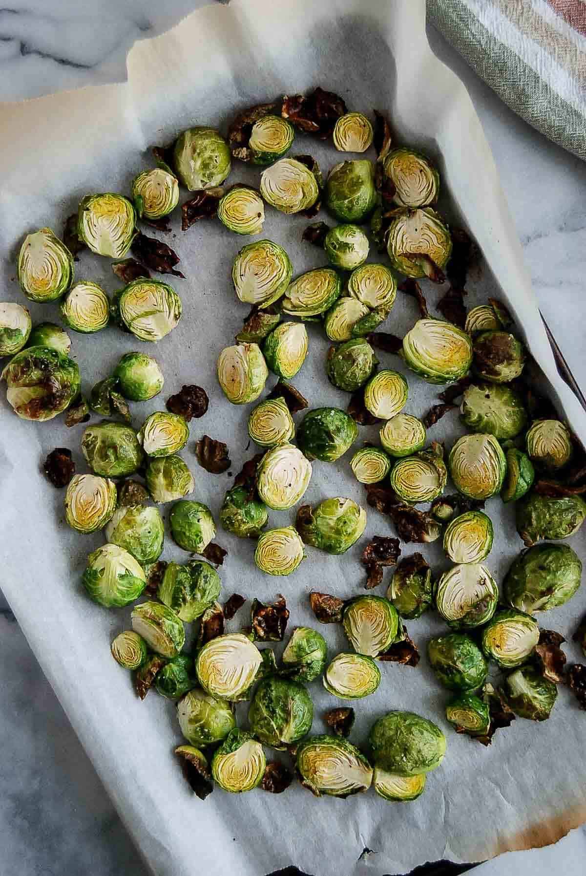 Roasted brussels sprouts on baking sheet.