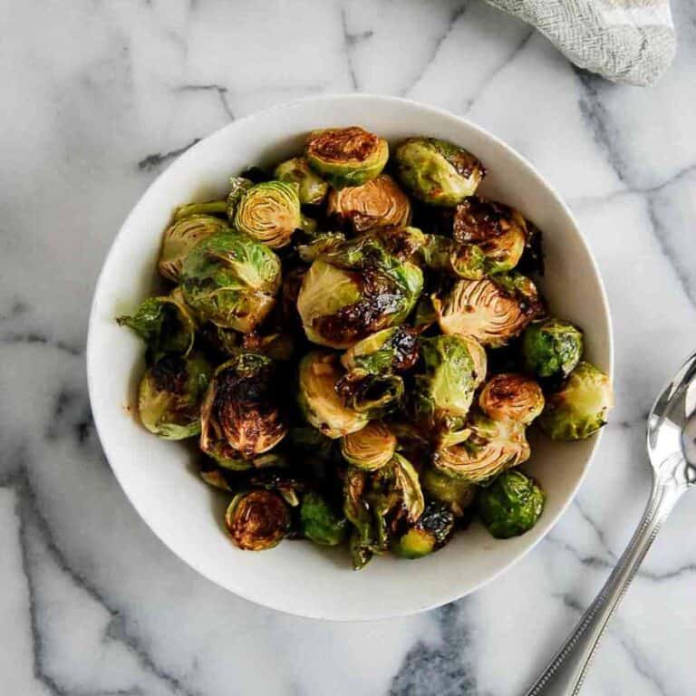 honey sriracha brussels sprouts in bowl on countertop.
