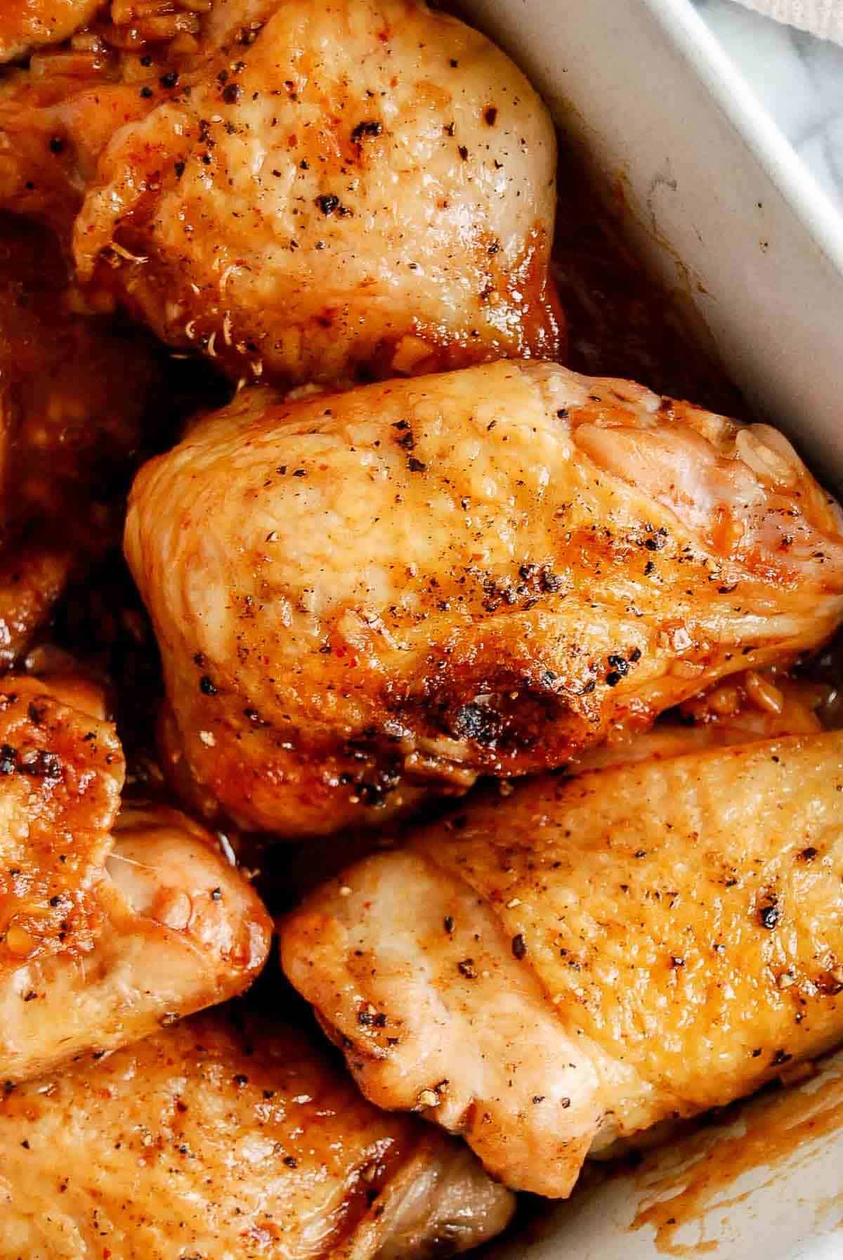 closeup of honey sriracha chicken in baking dish.